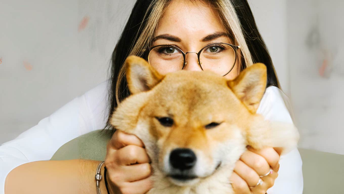 Woman loving on her pet.