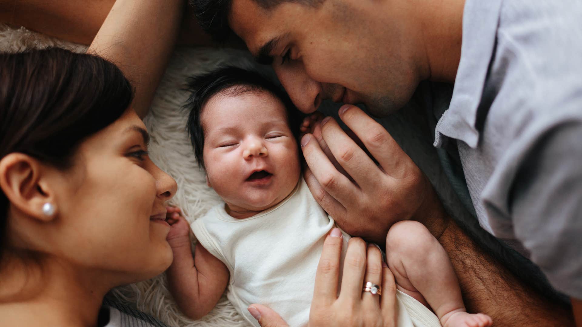 close-up of happy parents holding their newborn baby