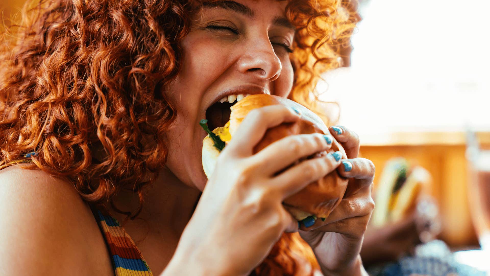 woman eating hamburger