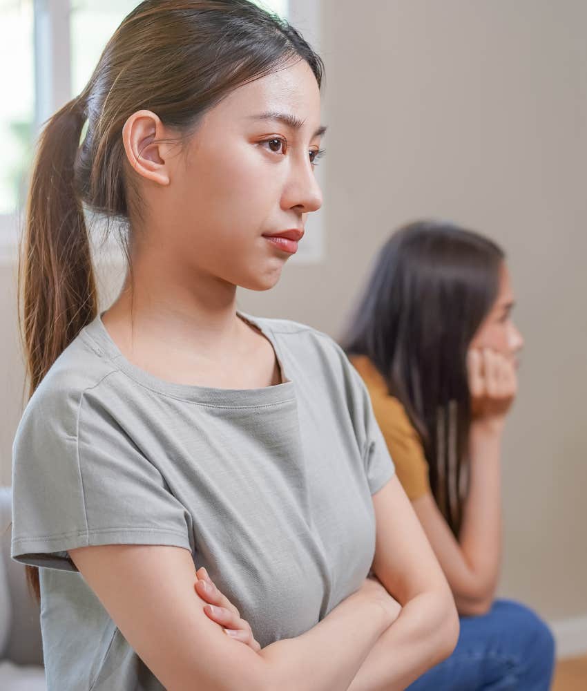 woman crosses her arms ignoring friend