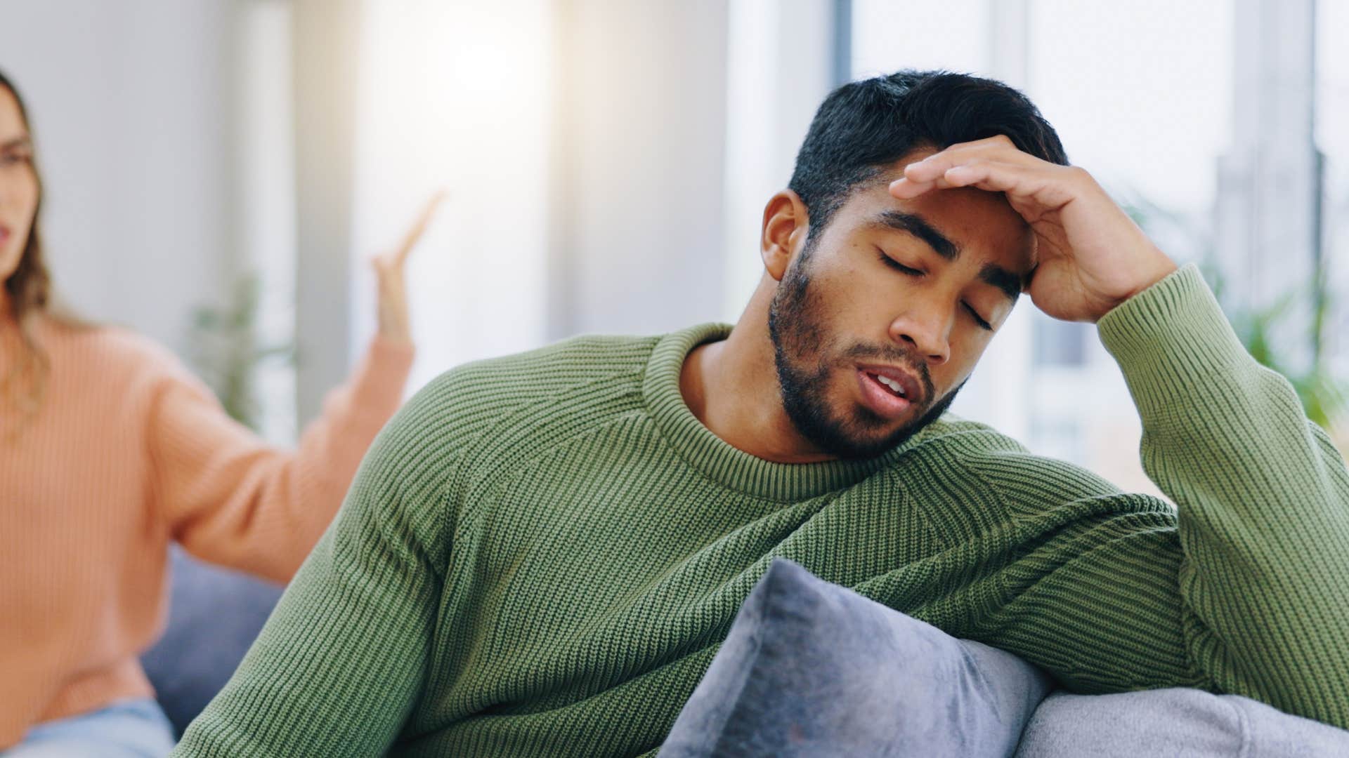 frustrated man turned away from angry wife