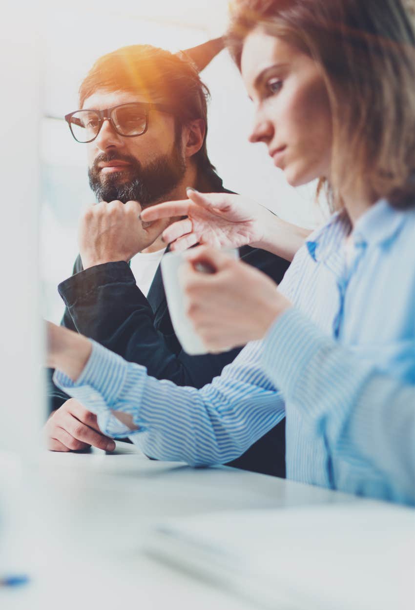 Man and woman at work looking for new job because values are out of sync