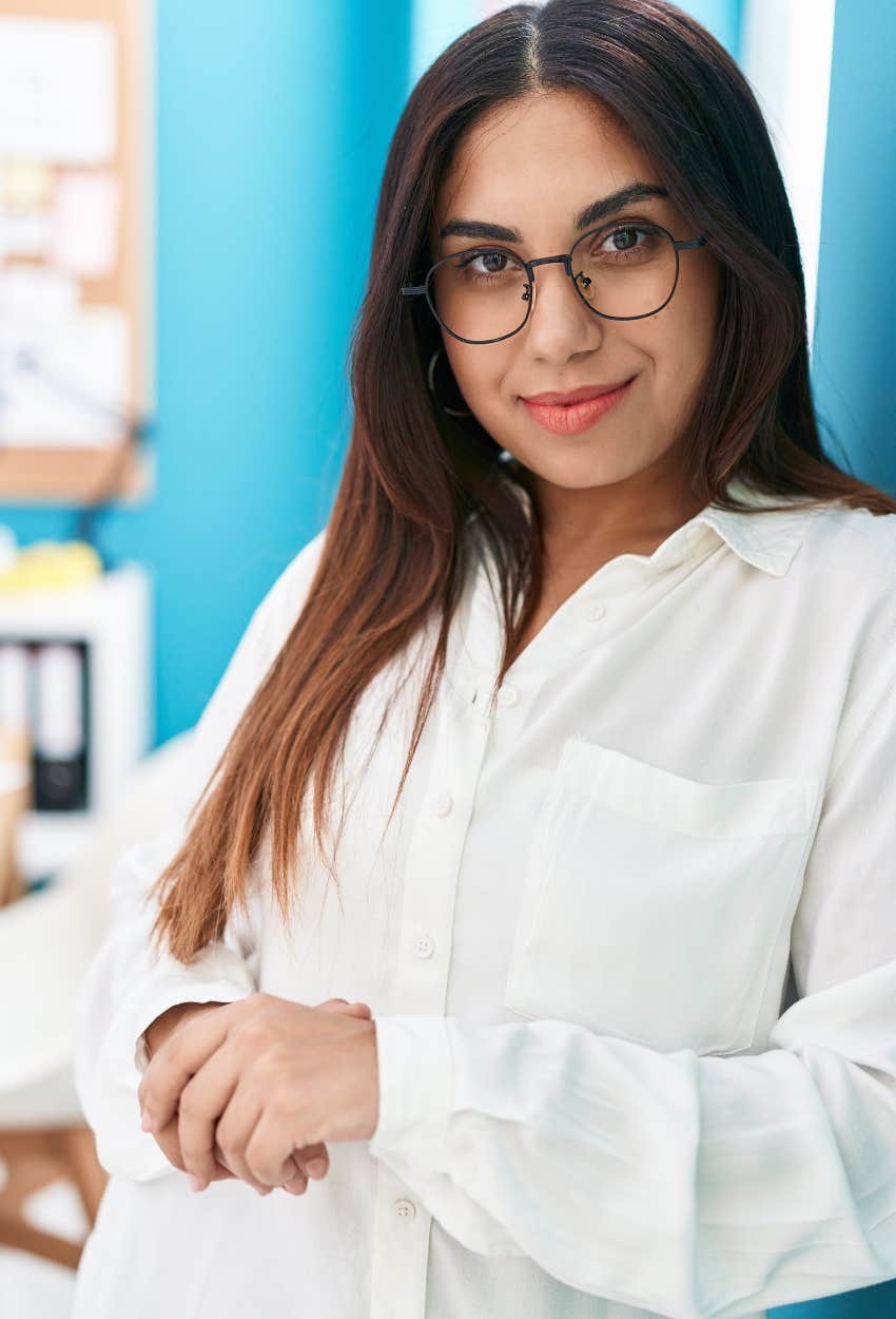 Smart woman at work in glasses sees signs to look for a new job 