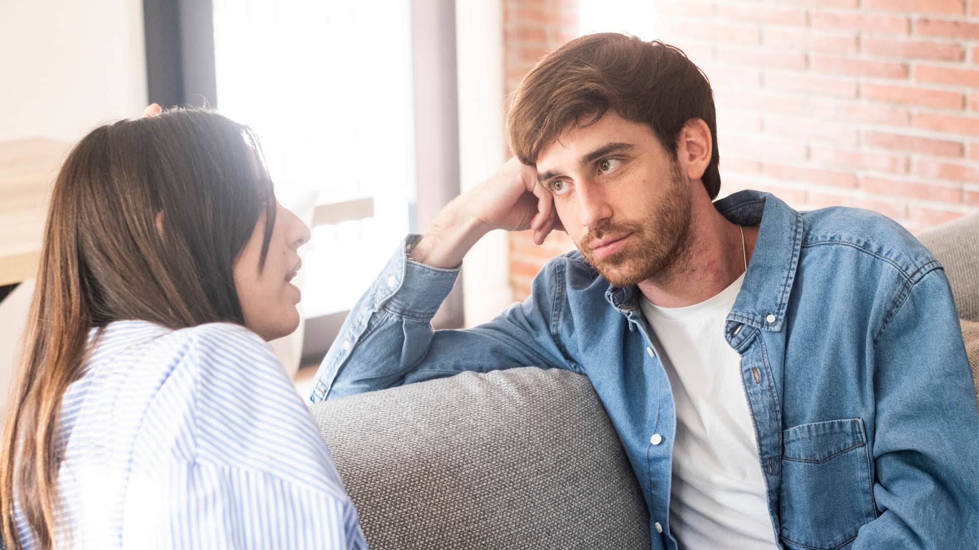 man listening to woman speak