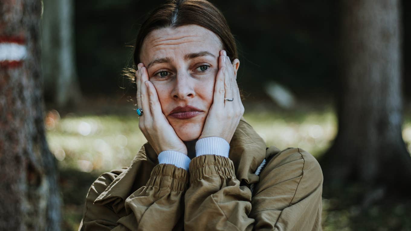 upset woman holding her face in her hands