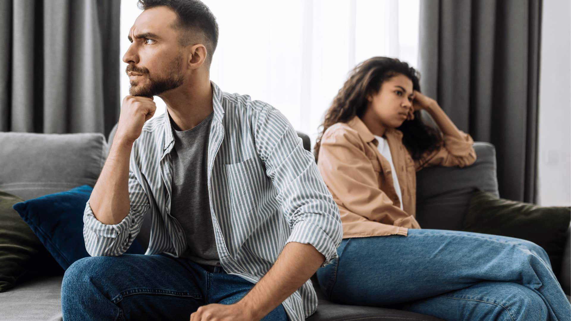 couple not talking to each other on couch