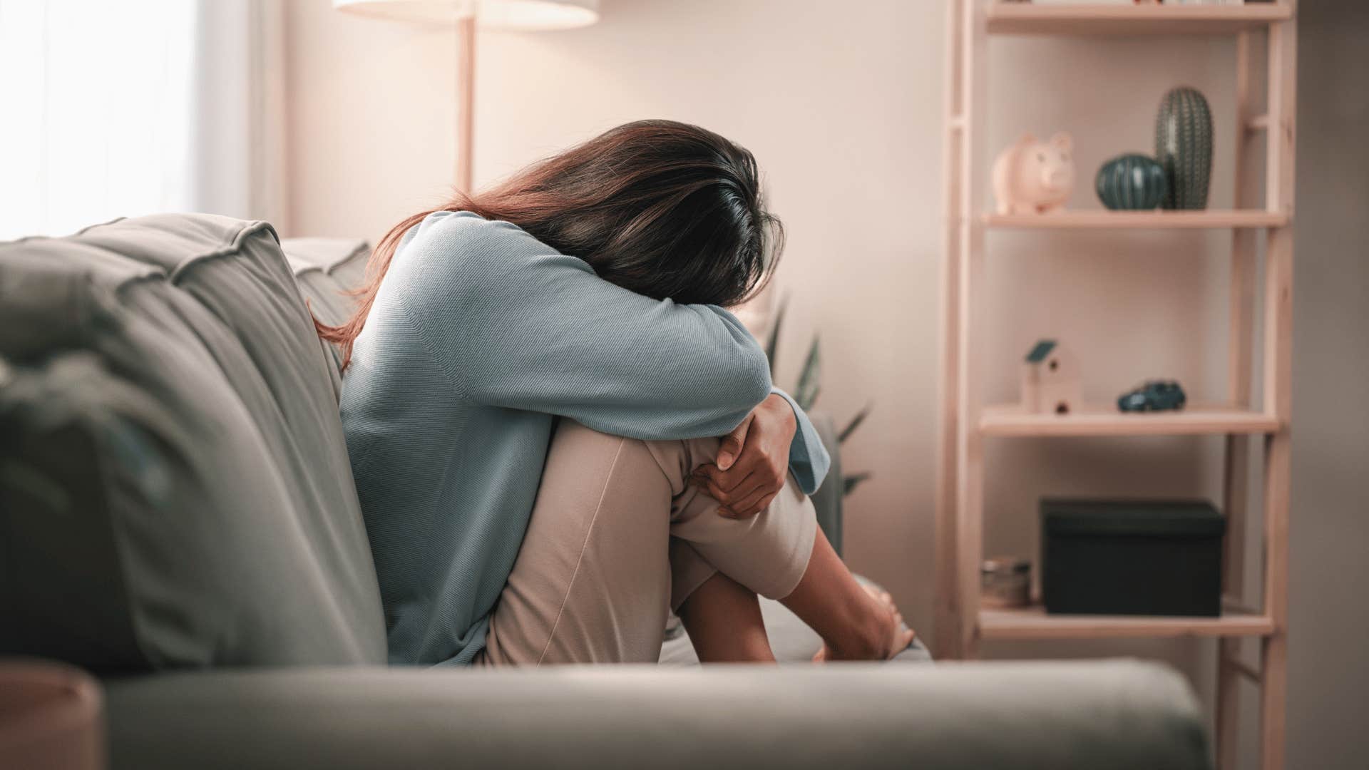 upset woman on couch