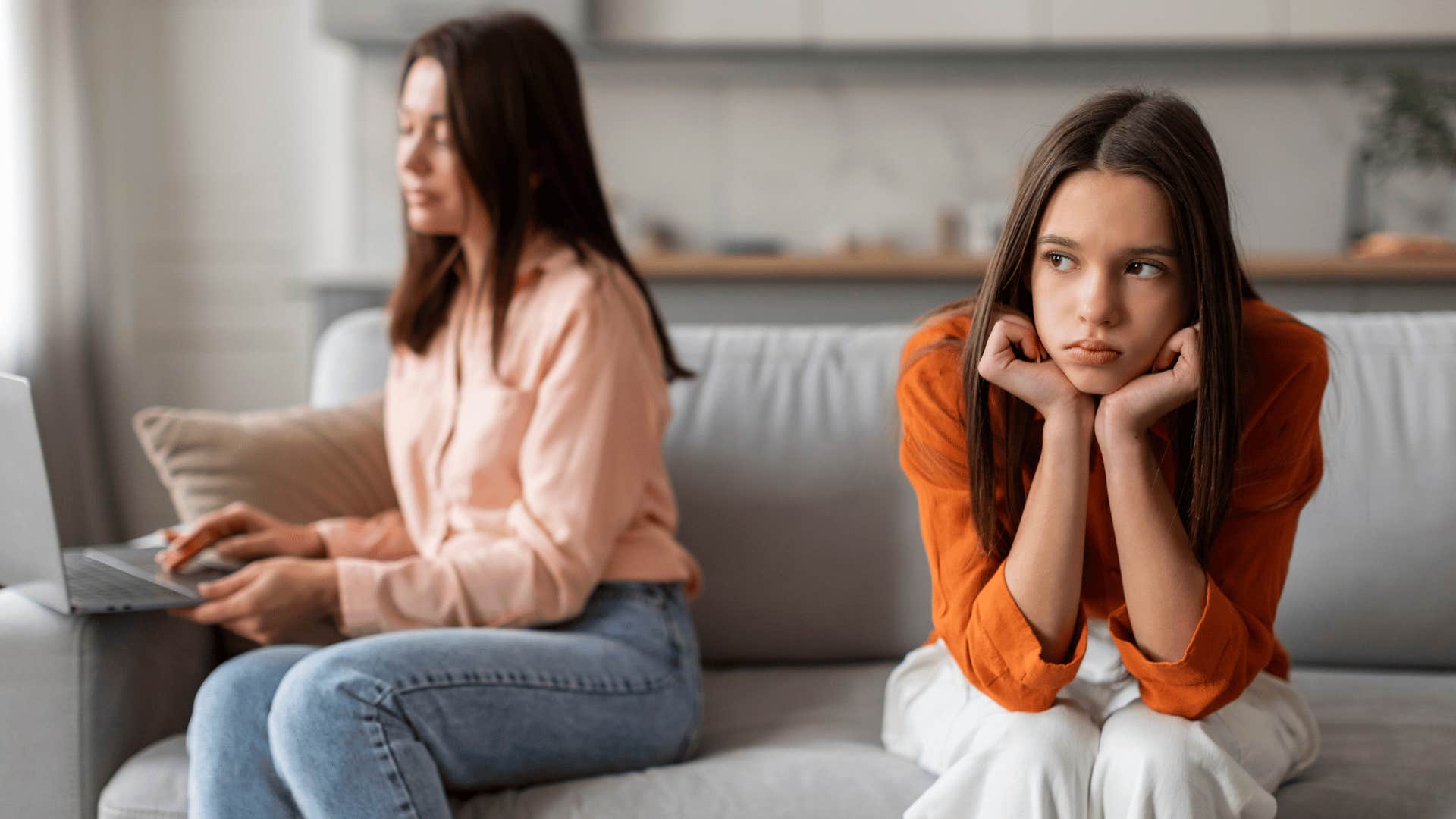 daughter being ignored by busy mom