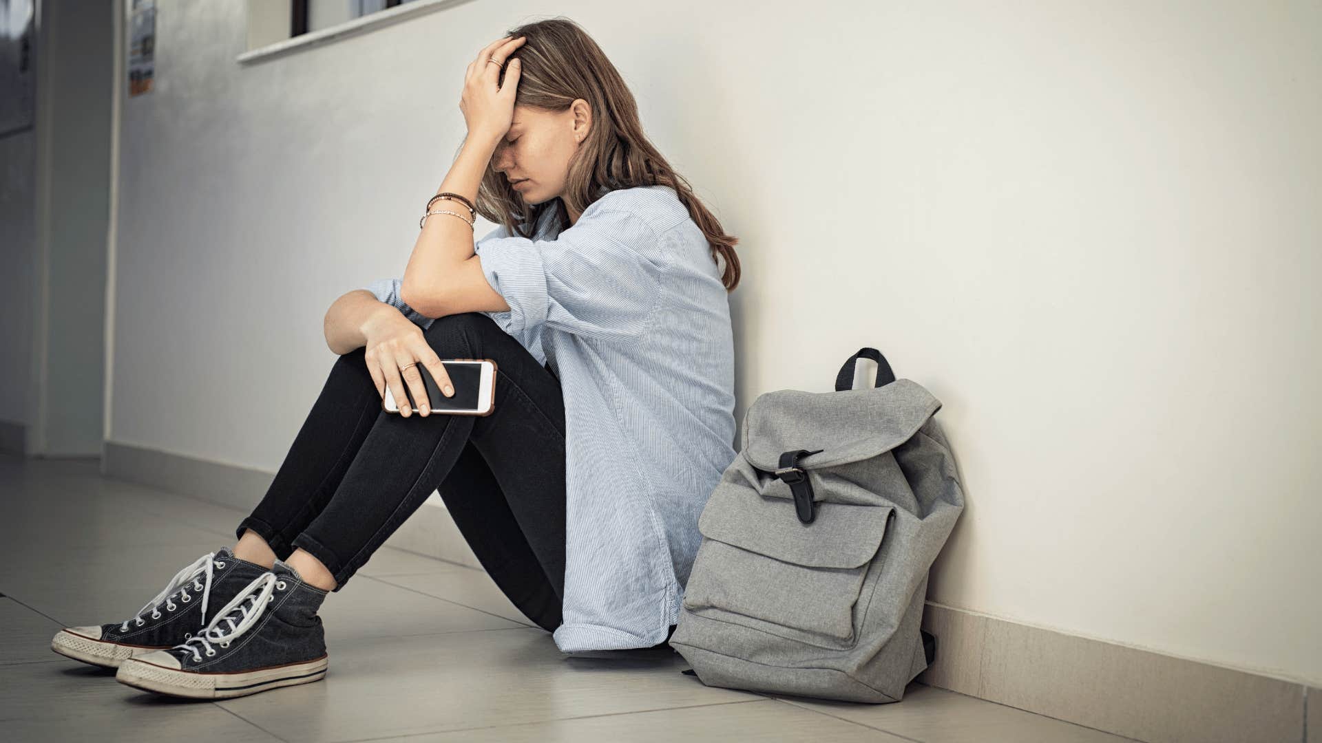 young woman crying in the hallway