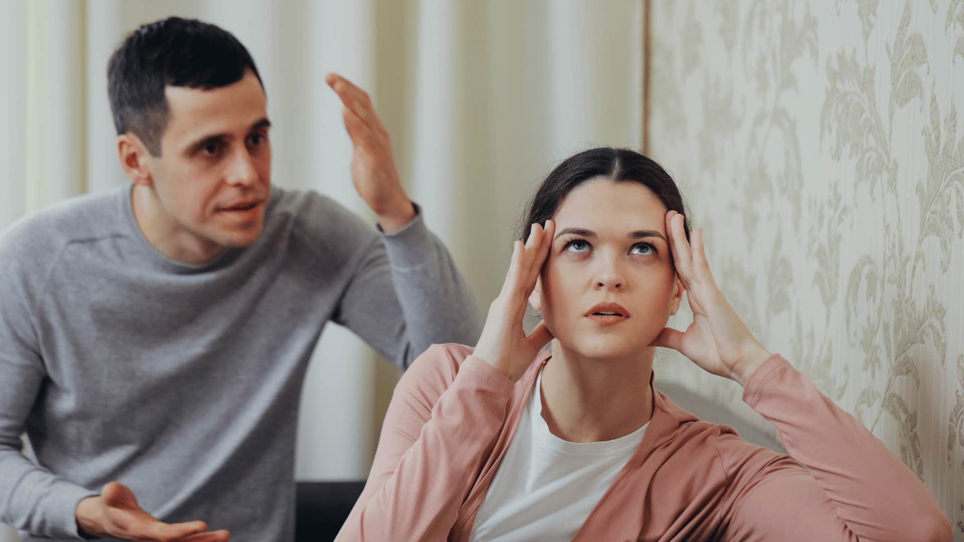 woman refusing to listen to annoyed man