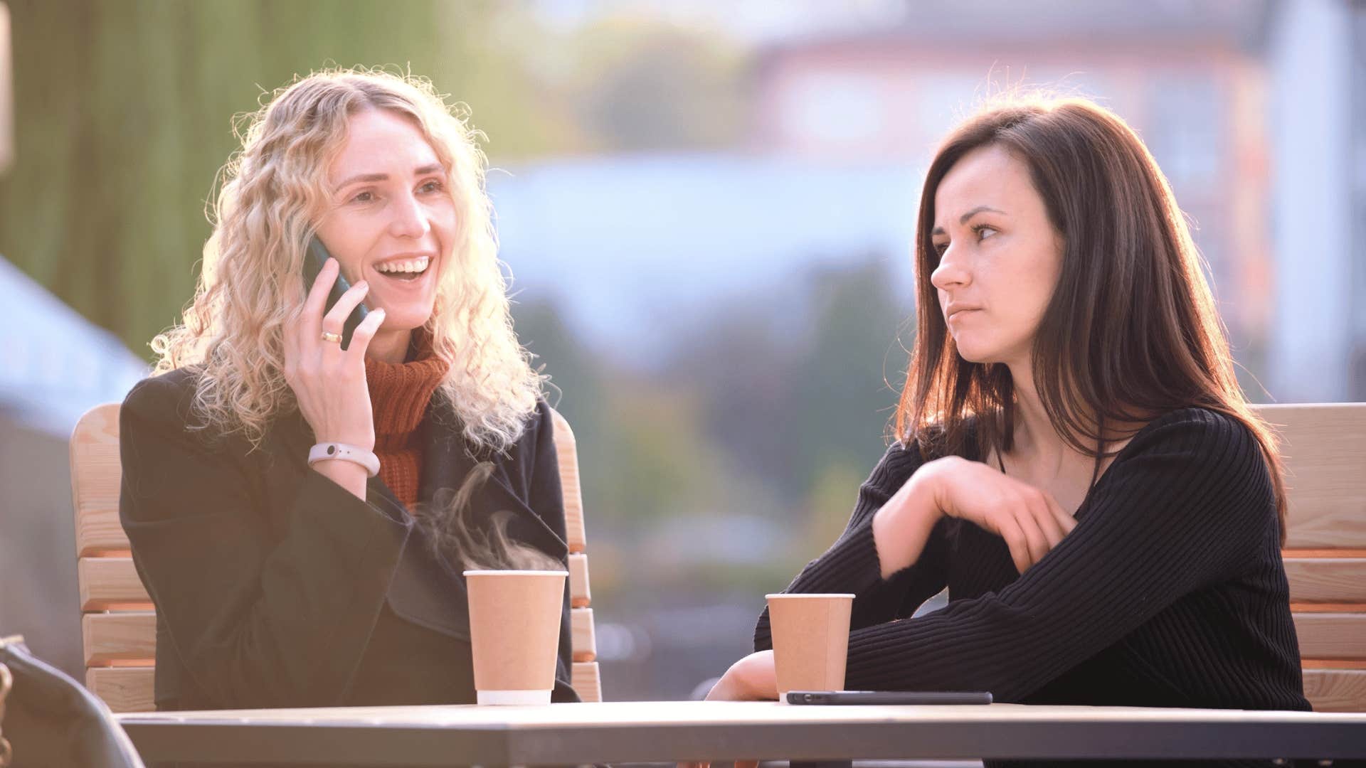 selfish woman on phone while at lunch with friend