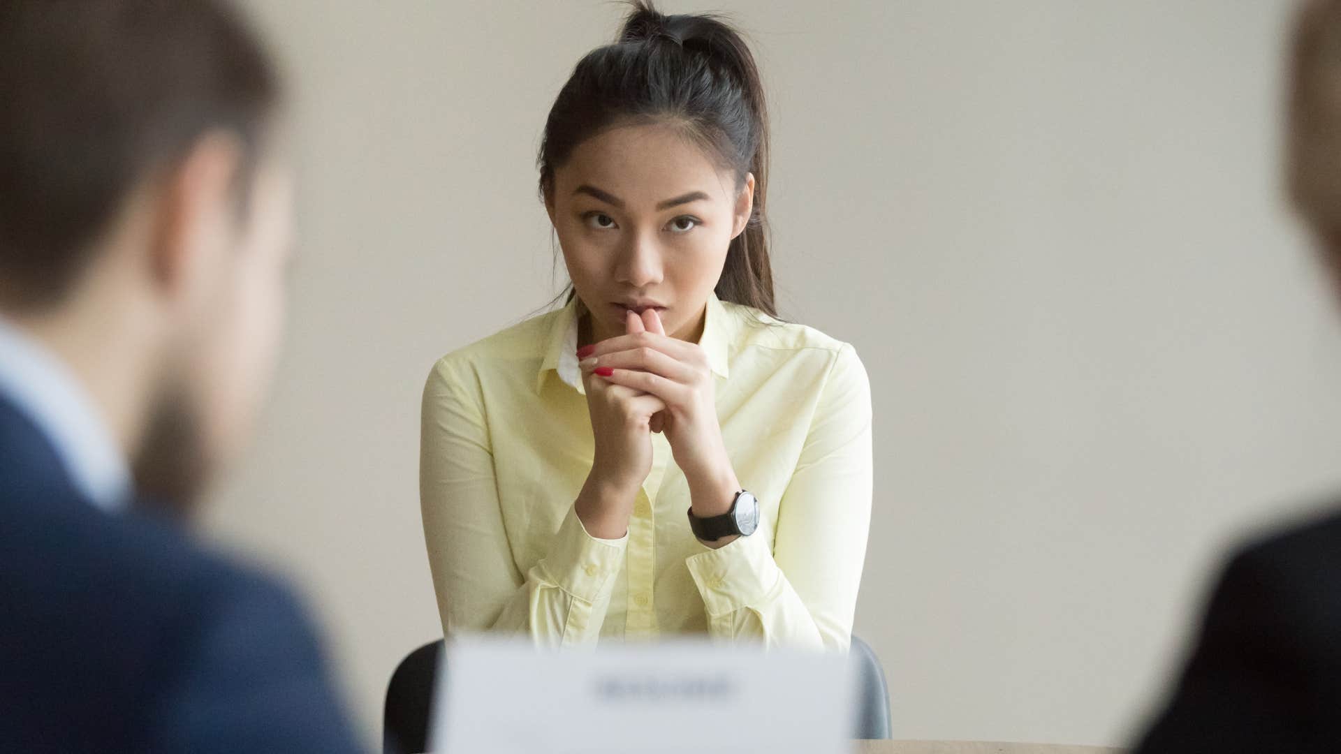 nervous woman sitting at her desk