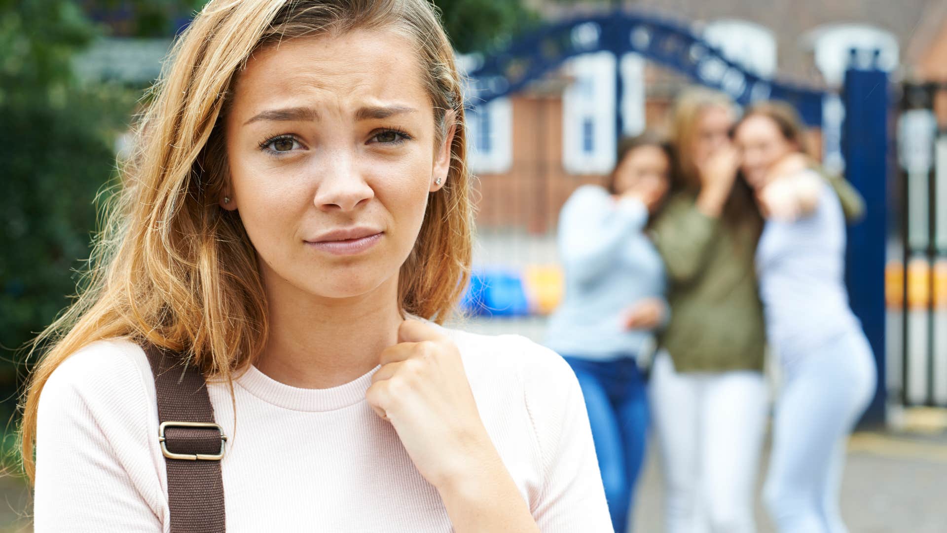 group of girls not being kind to another girl