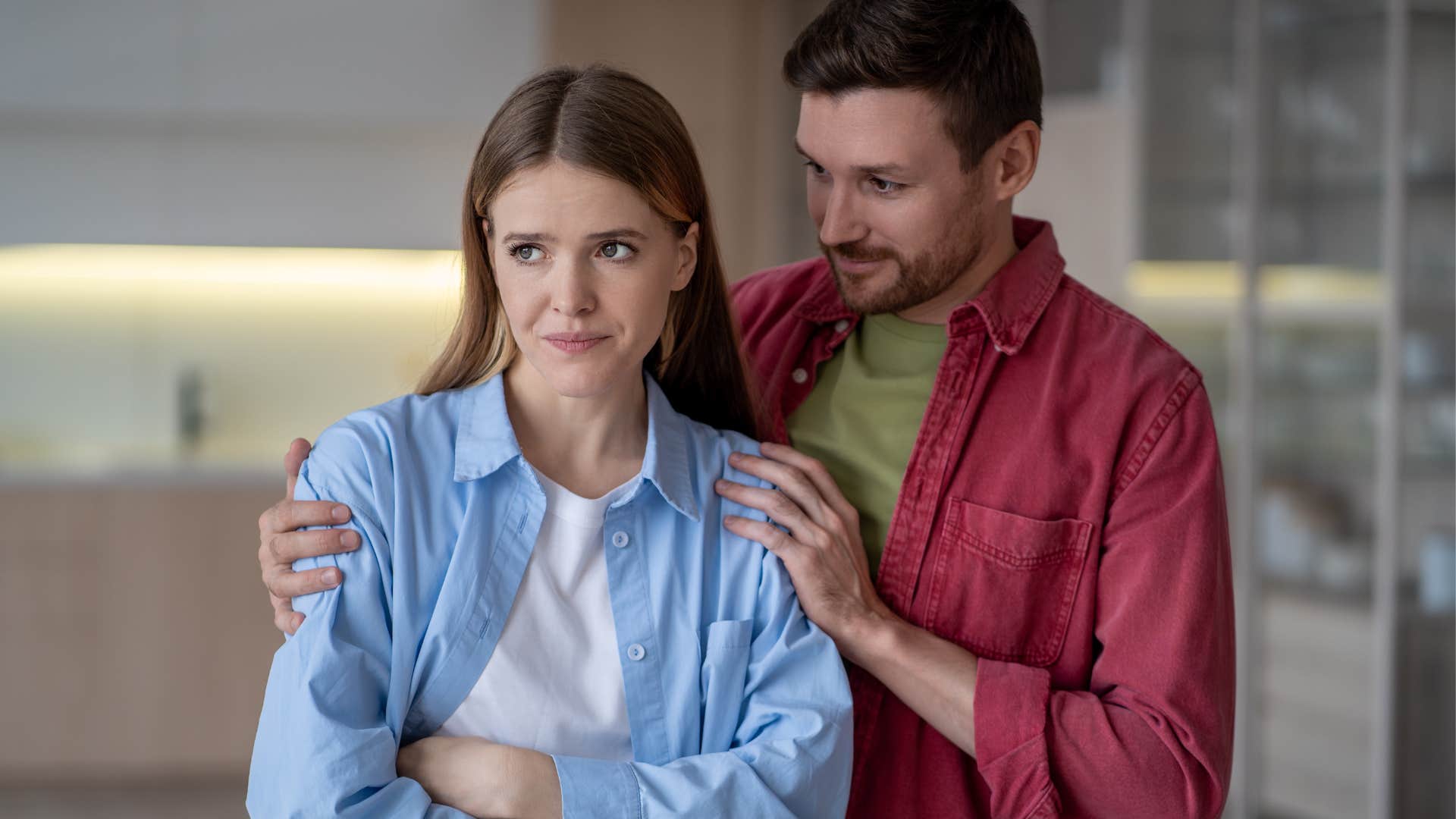 man comforting emotional woman