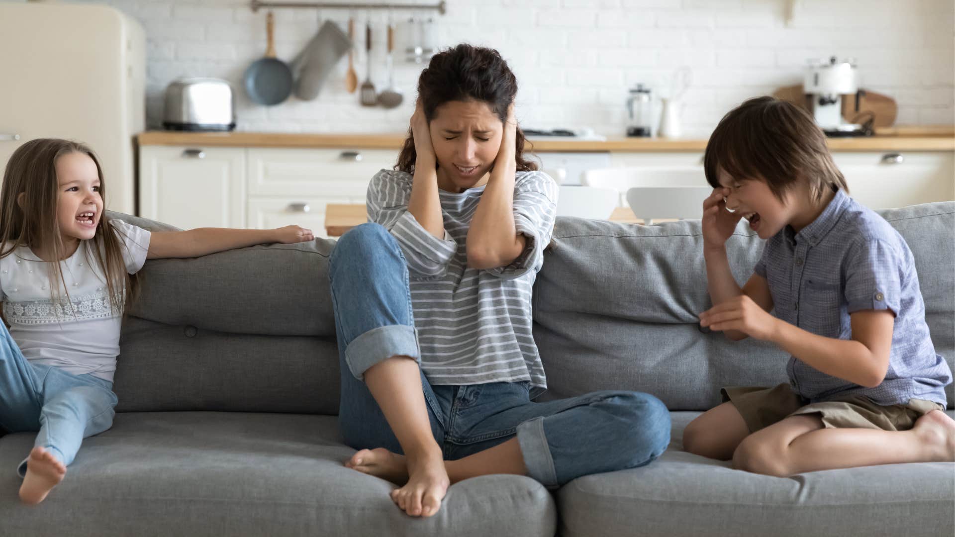 woman reacting to loud noise from kids