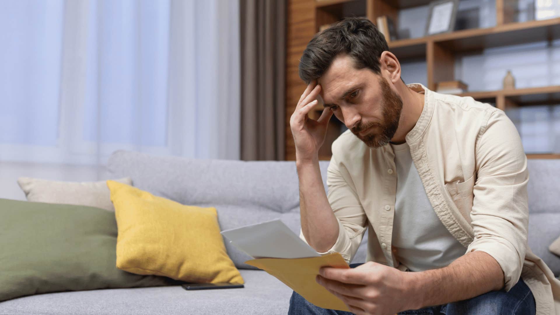 rejected man looking at papers