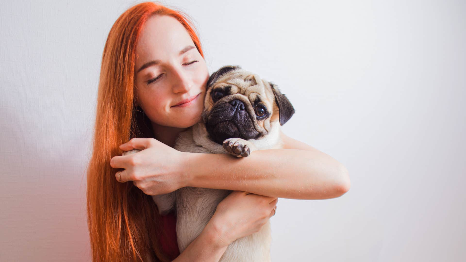 young woman holding pug