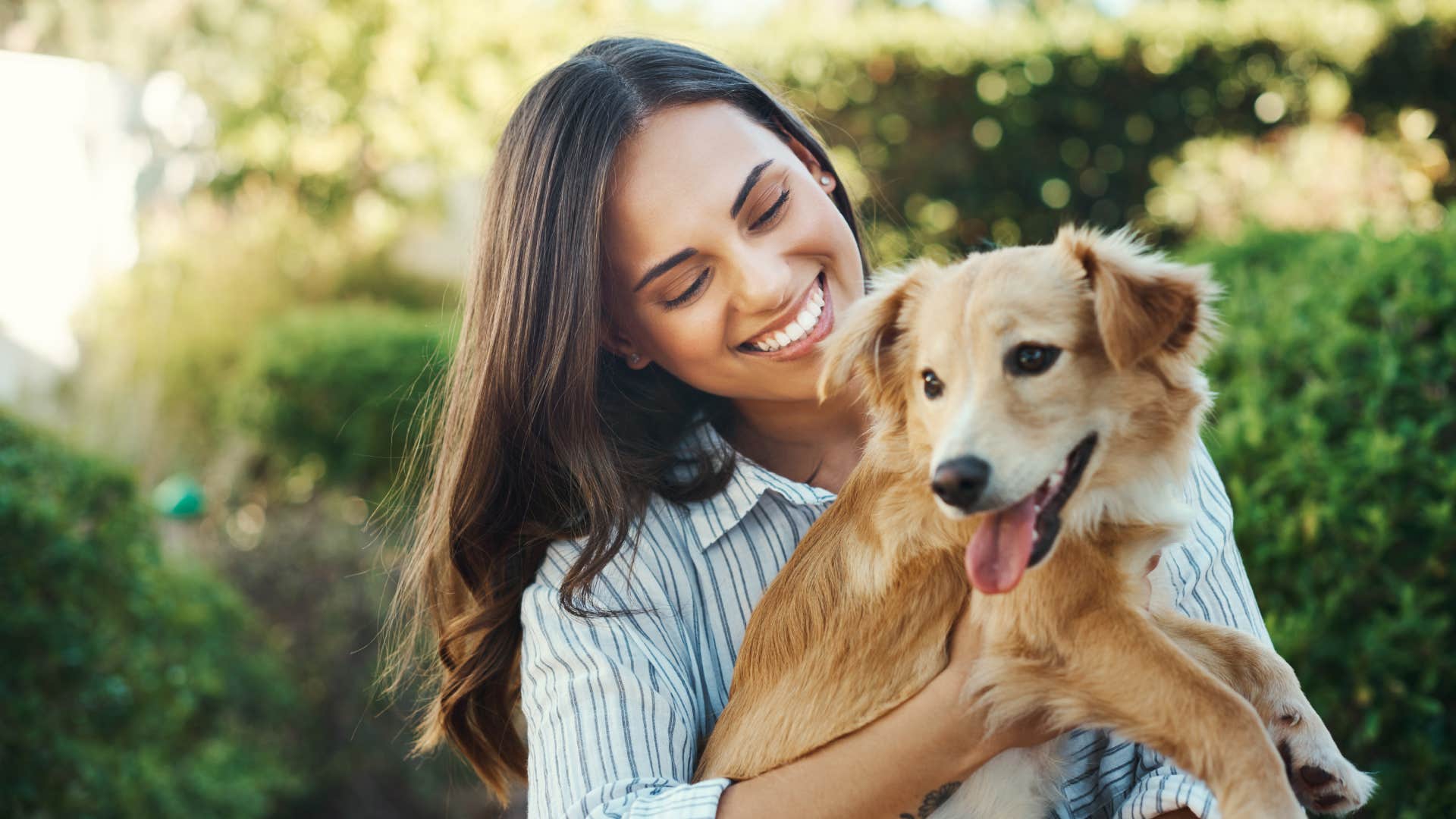 woman playing with dog outside 