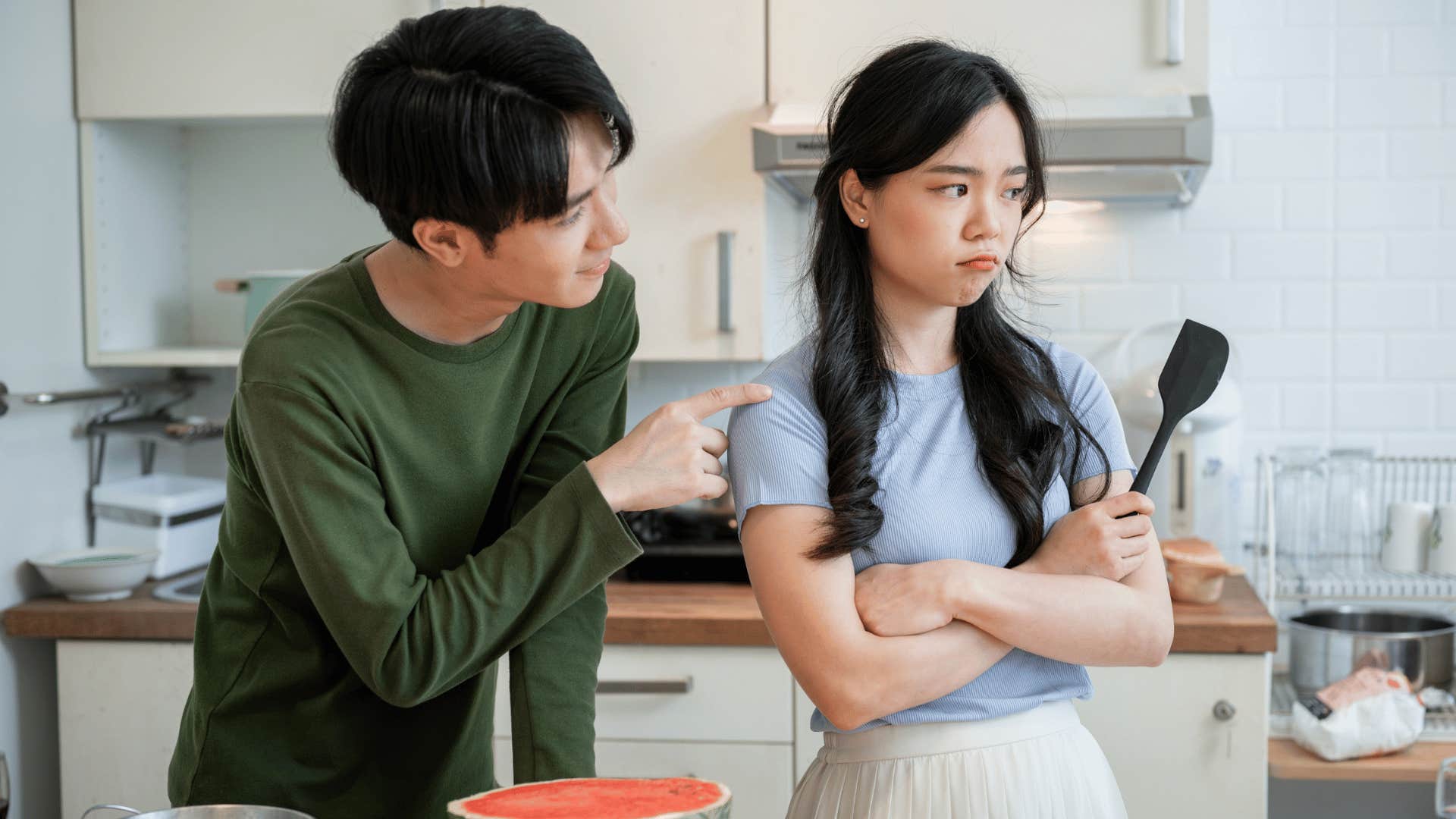 man love bombing woman in kitchen