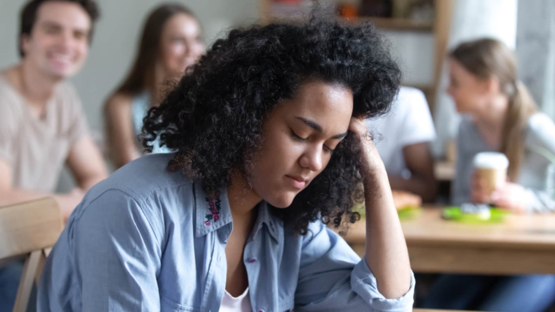 exhausted woman with people talking about her