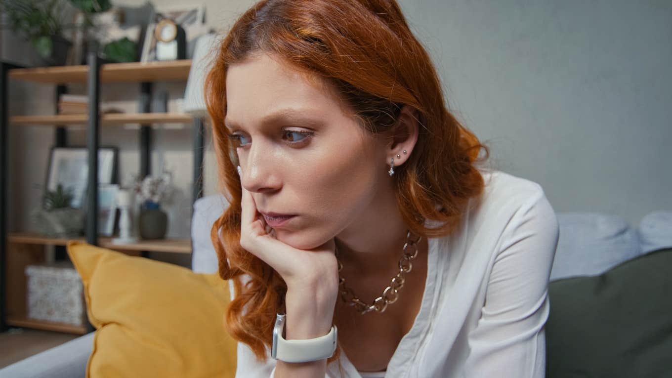 Sad woman holding her head in her hands.