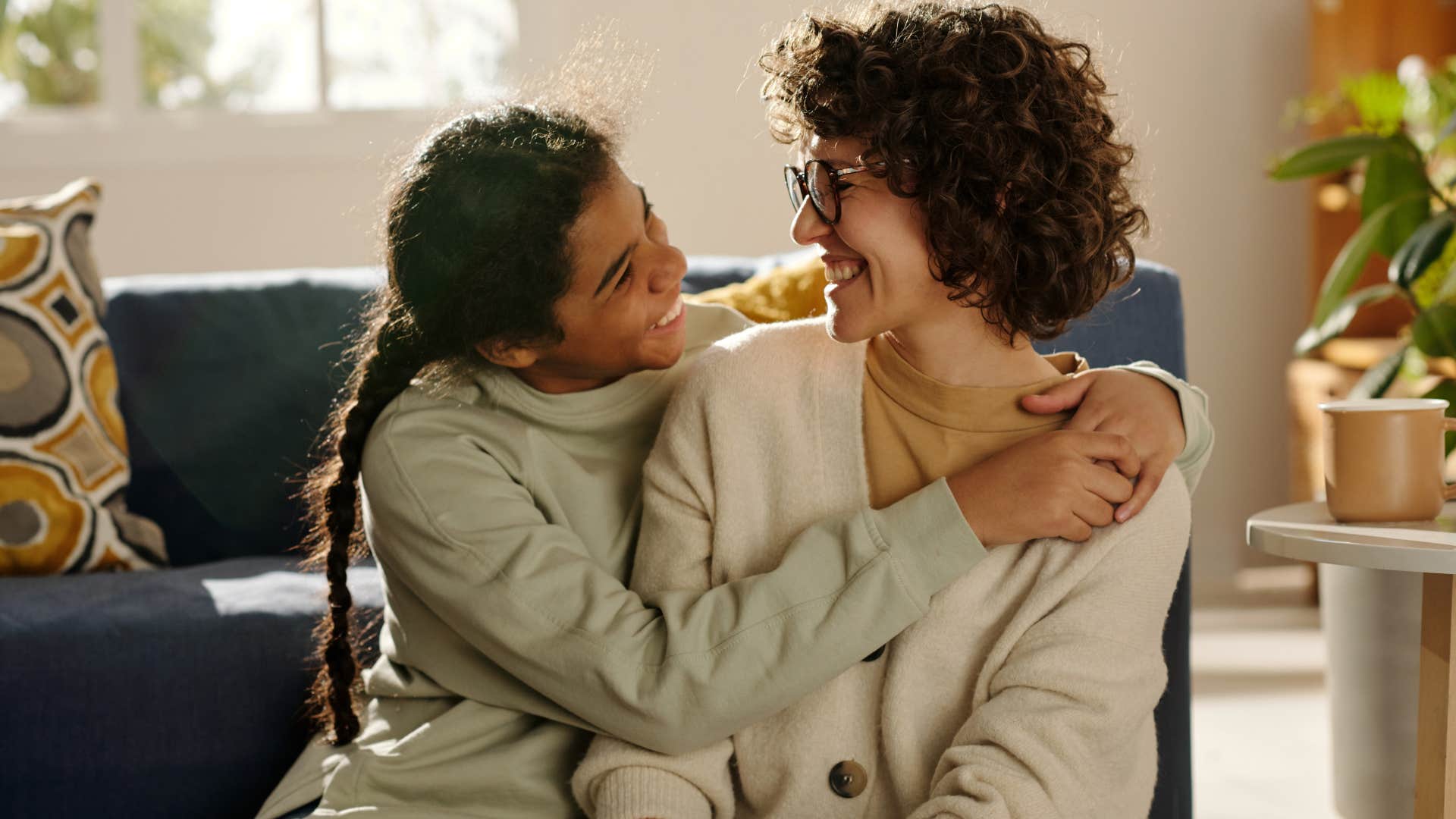 Two women smiling and hugging each other