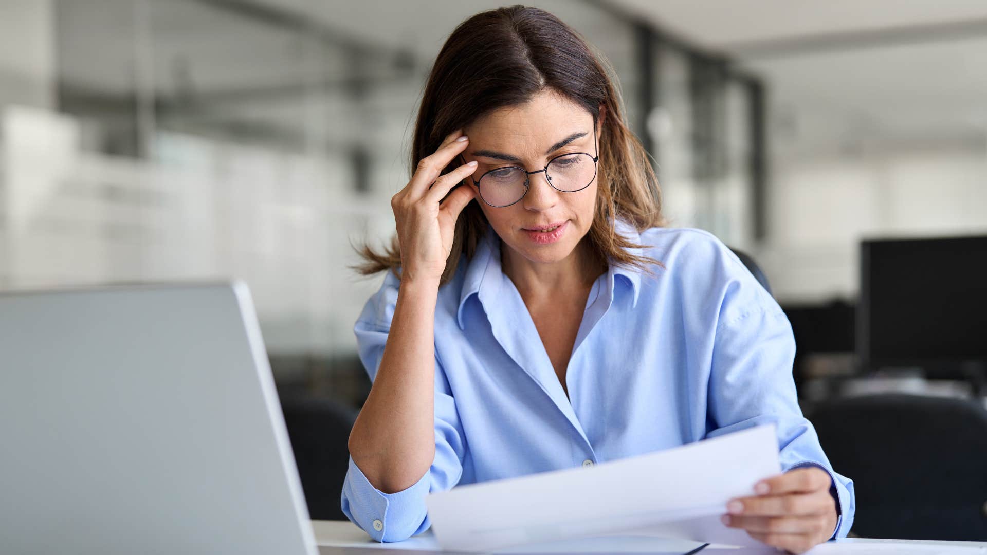 Stressed woman sitting at her work desk