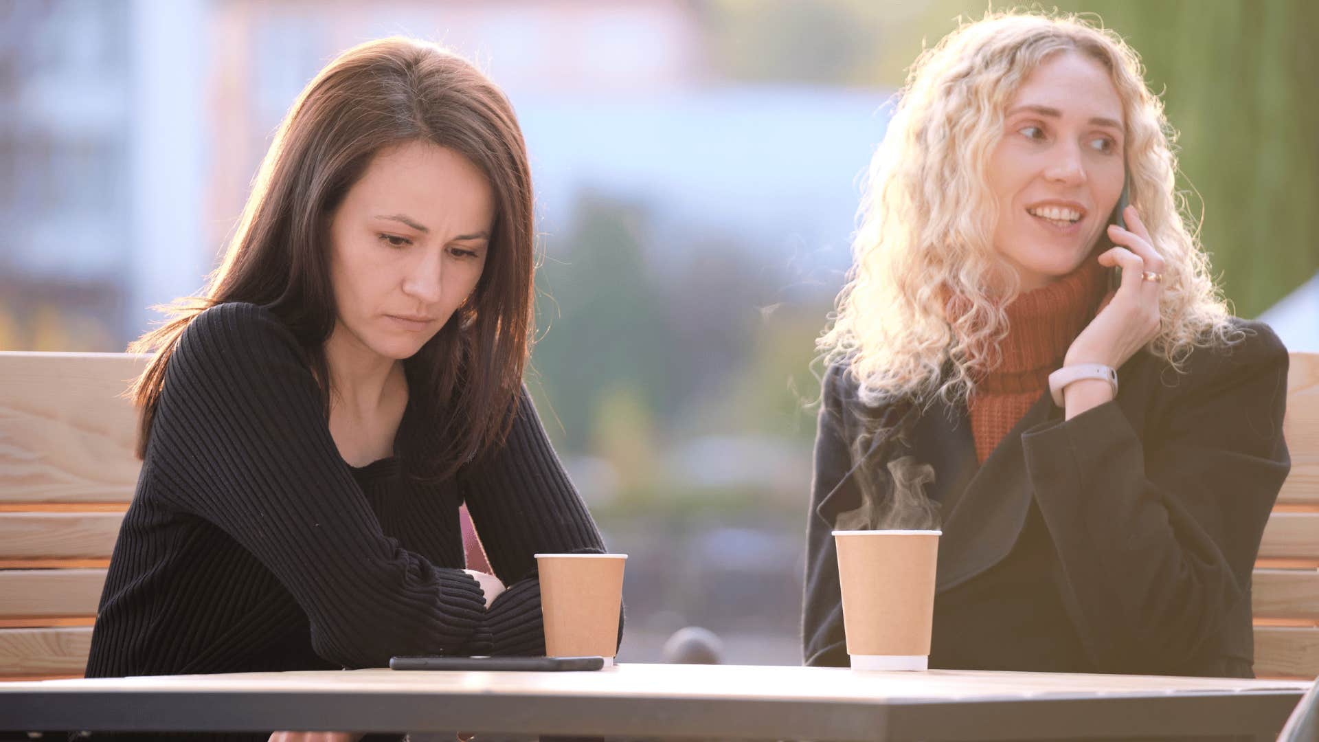 woman ignoring friend while on the phone