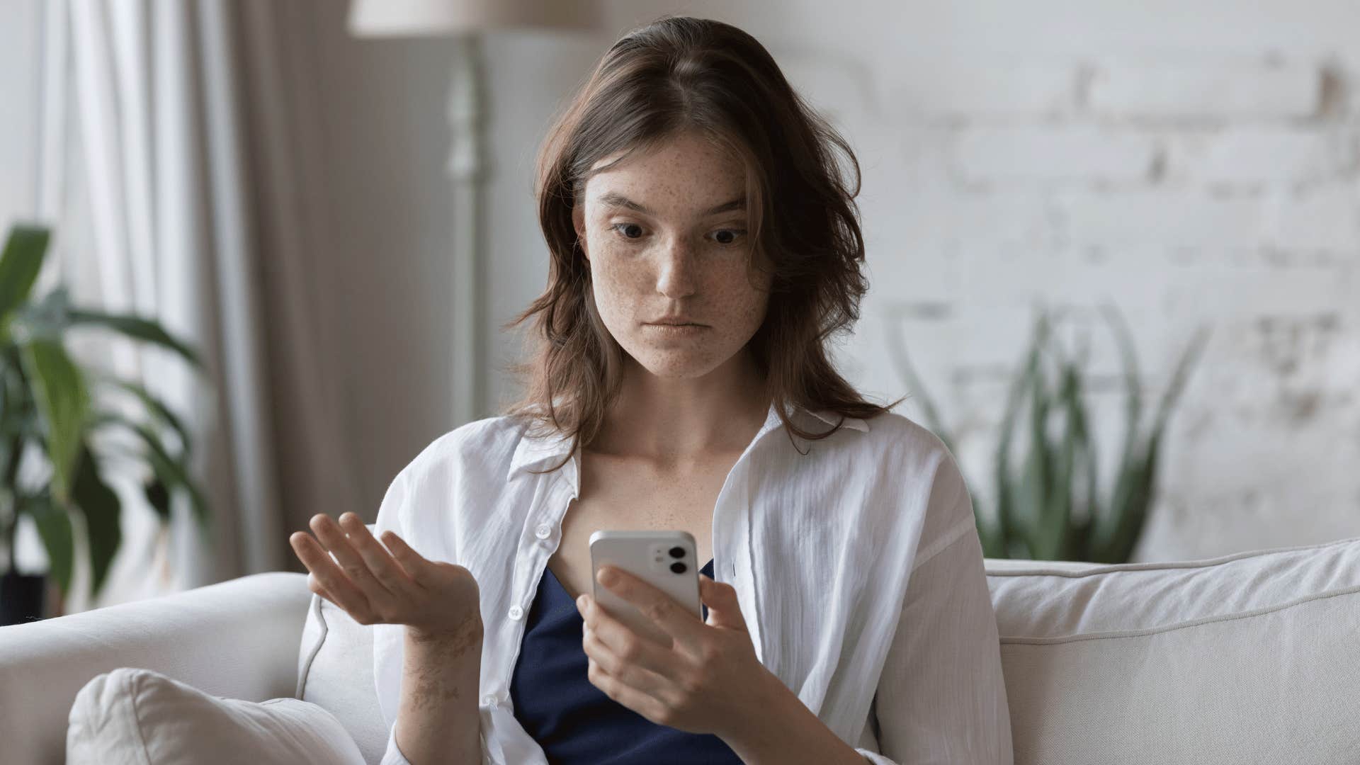 annoyed woman looking at her phone annoyed 