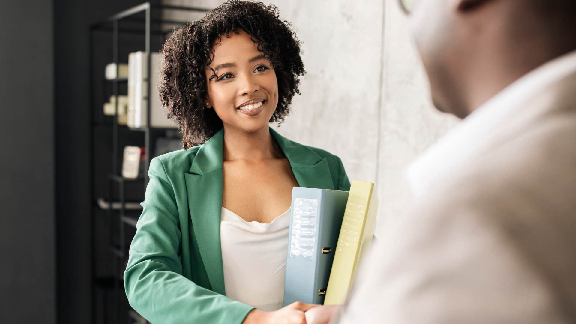 happy woman shaking hands with co-worker