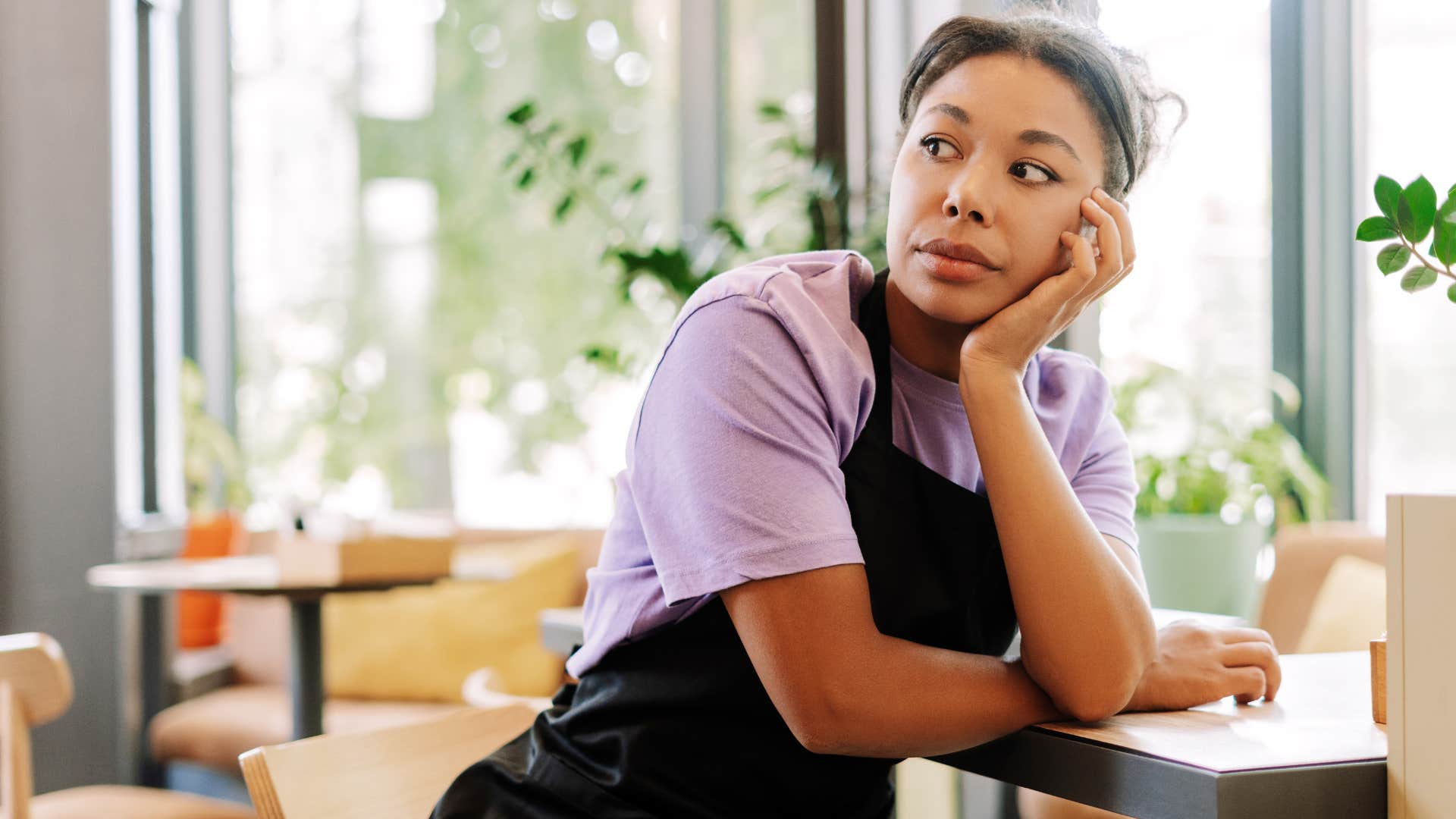 stressed woman leaning on a table