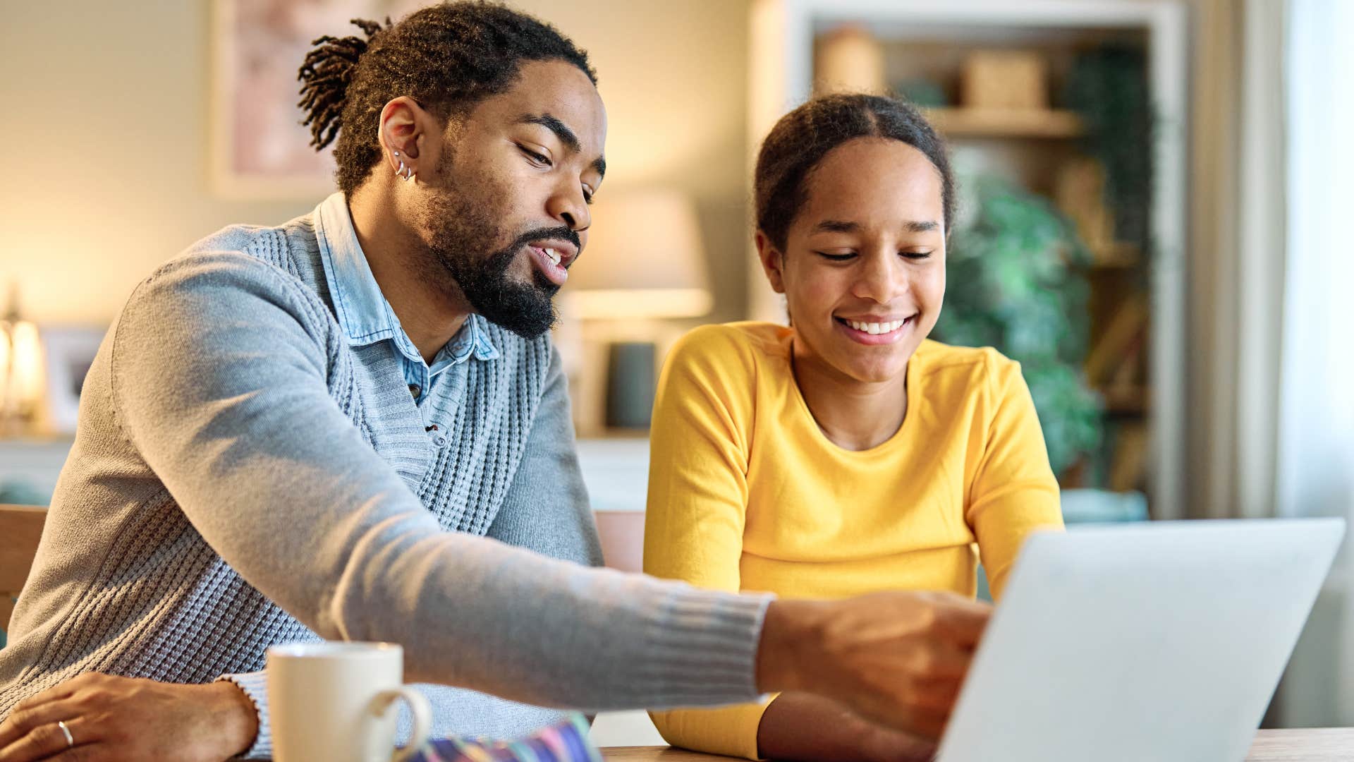 man helping daughter with homework