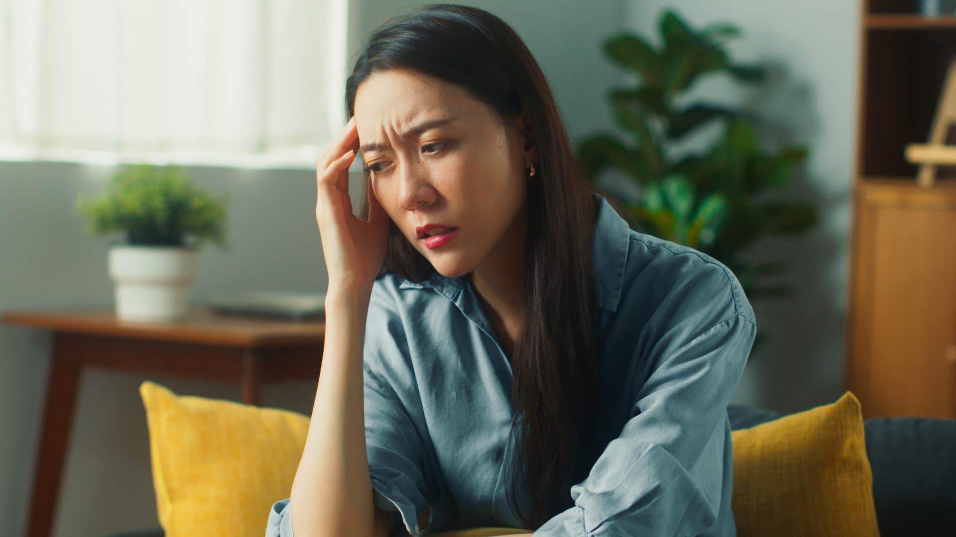 tired woman touching her head