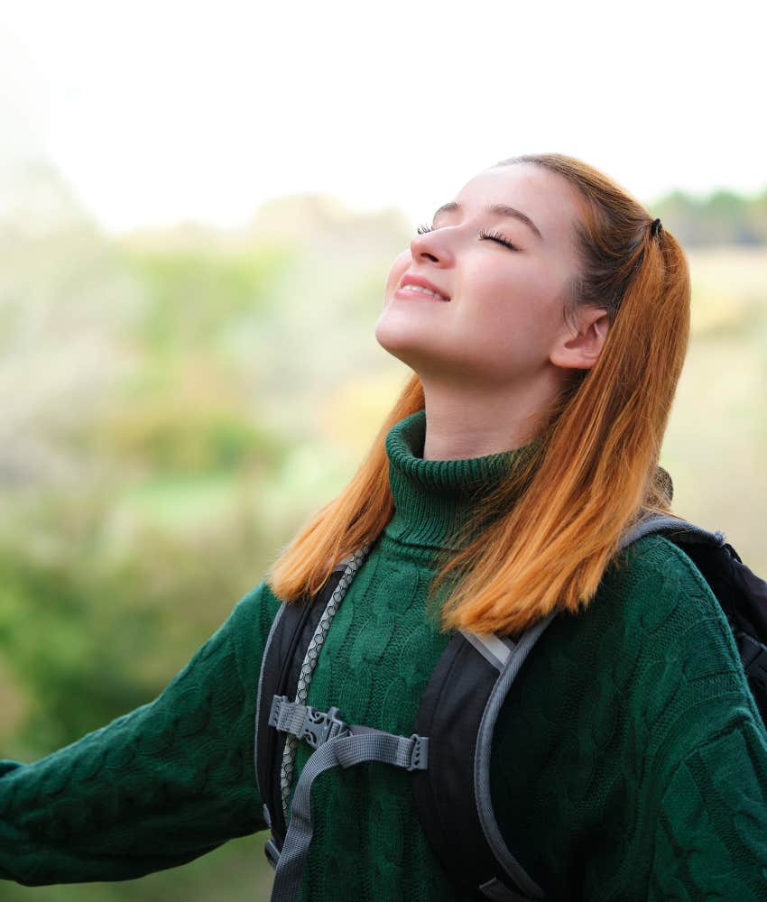 Young woman outdoors, peacefully embracing that anxiety is natural and not lonely