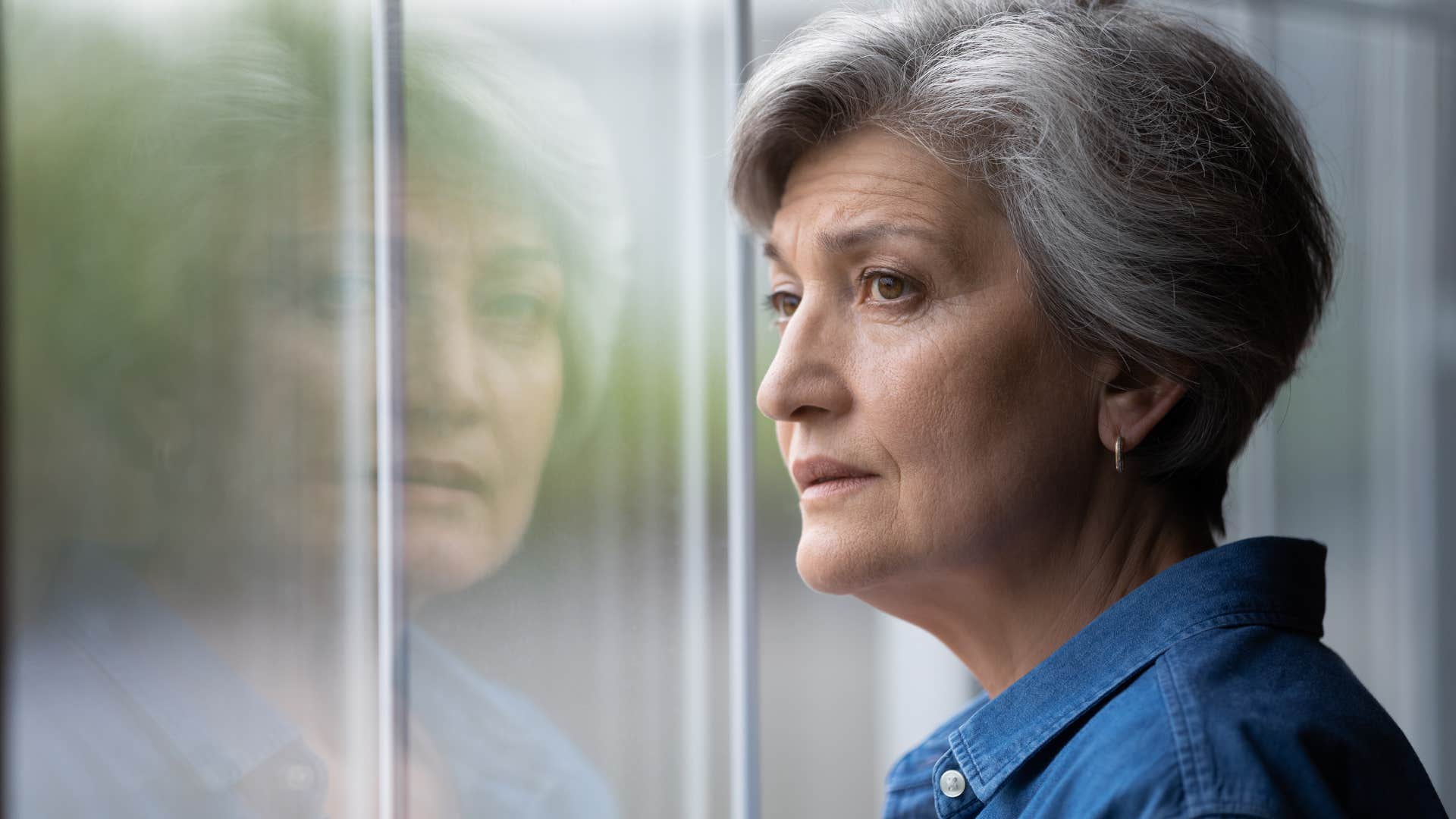 older woman looking out a window