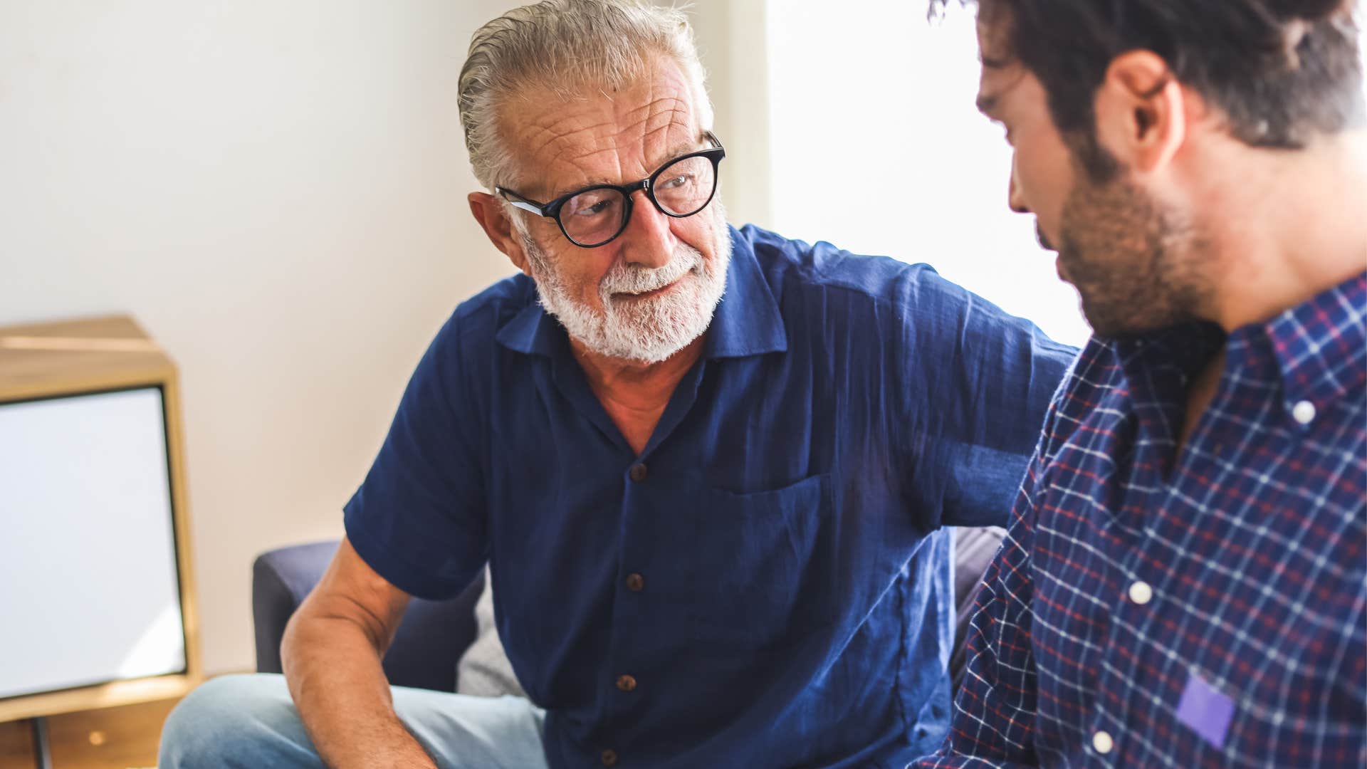 older man reacting to son's trauma