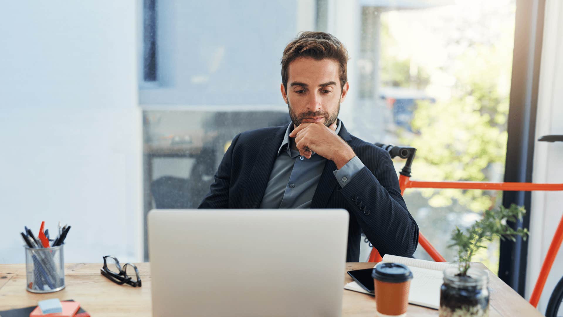 man concentrating at desk