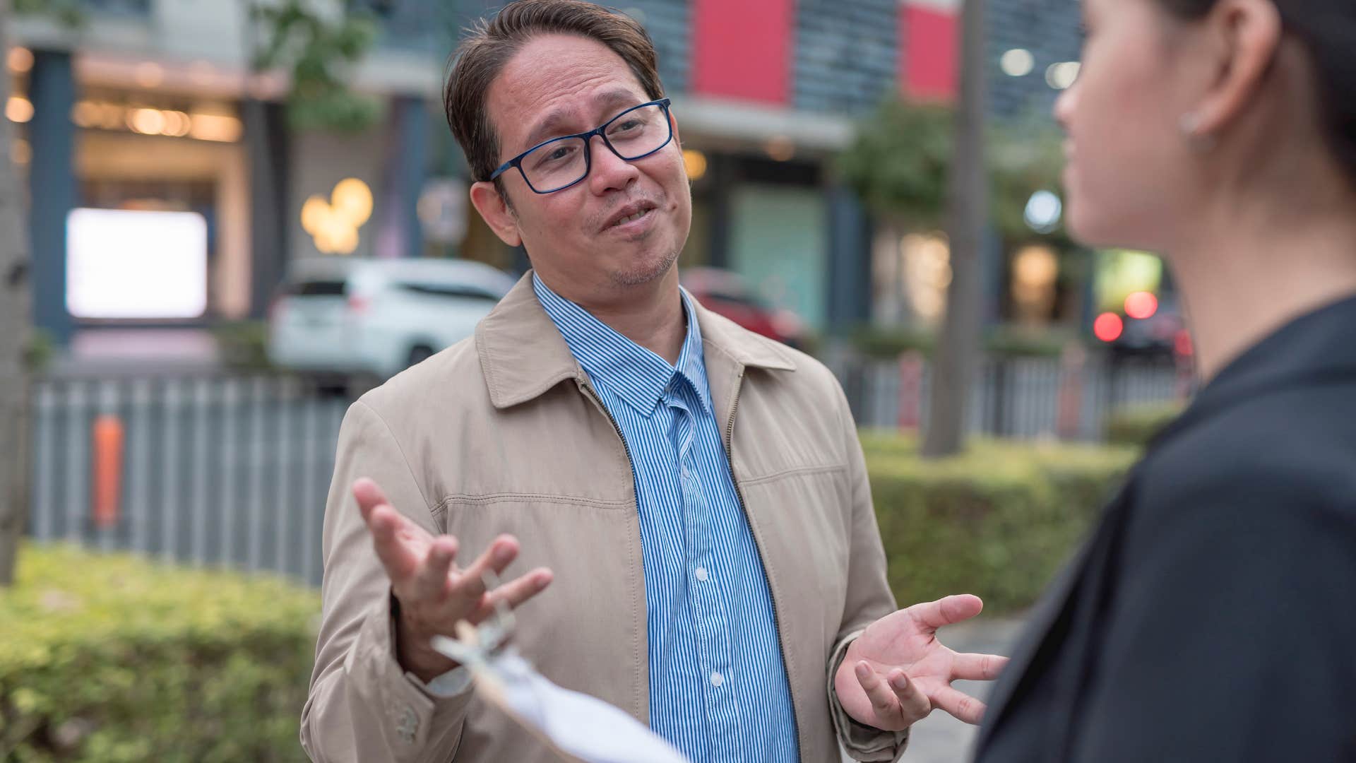 man talking to a woman on the street