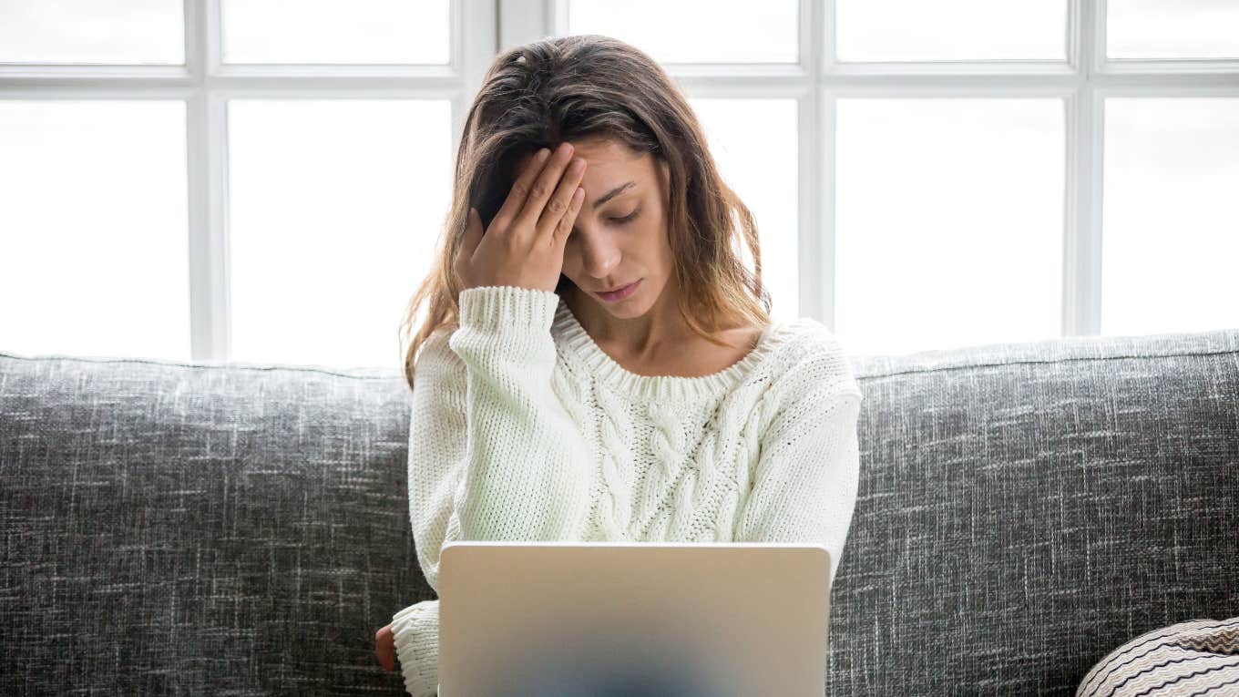 upset student looking at PhD program rejection on laptop