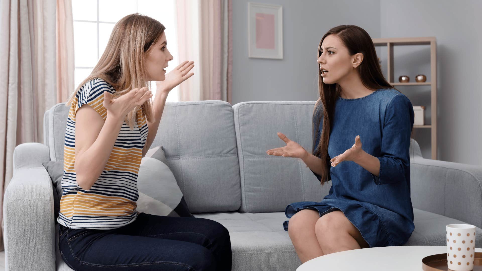 two women arguing on the couch