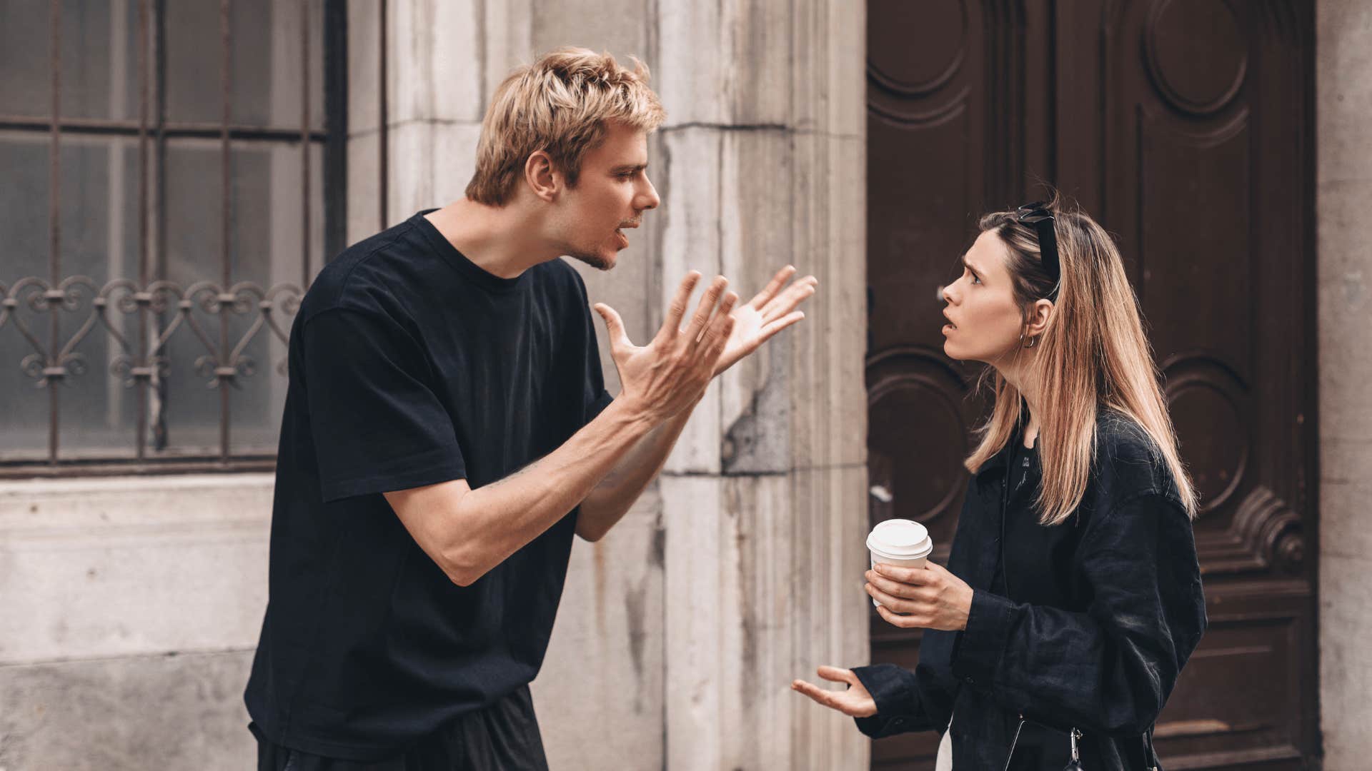 couple arguing outside of building