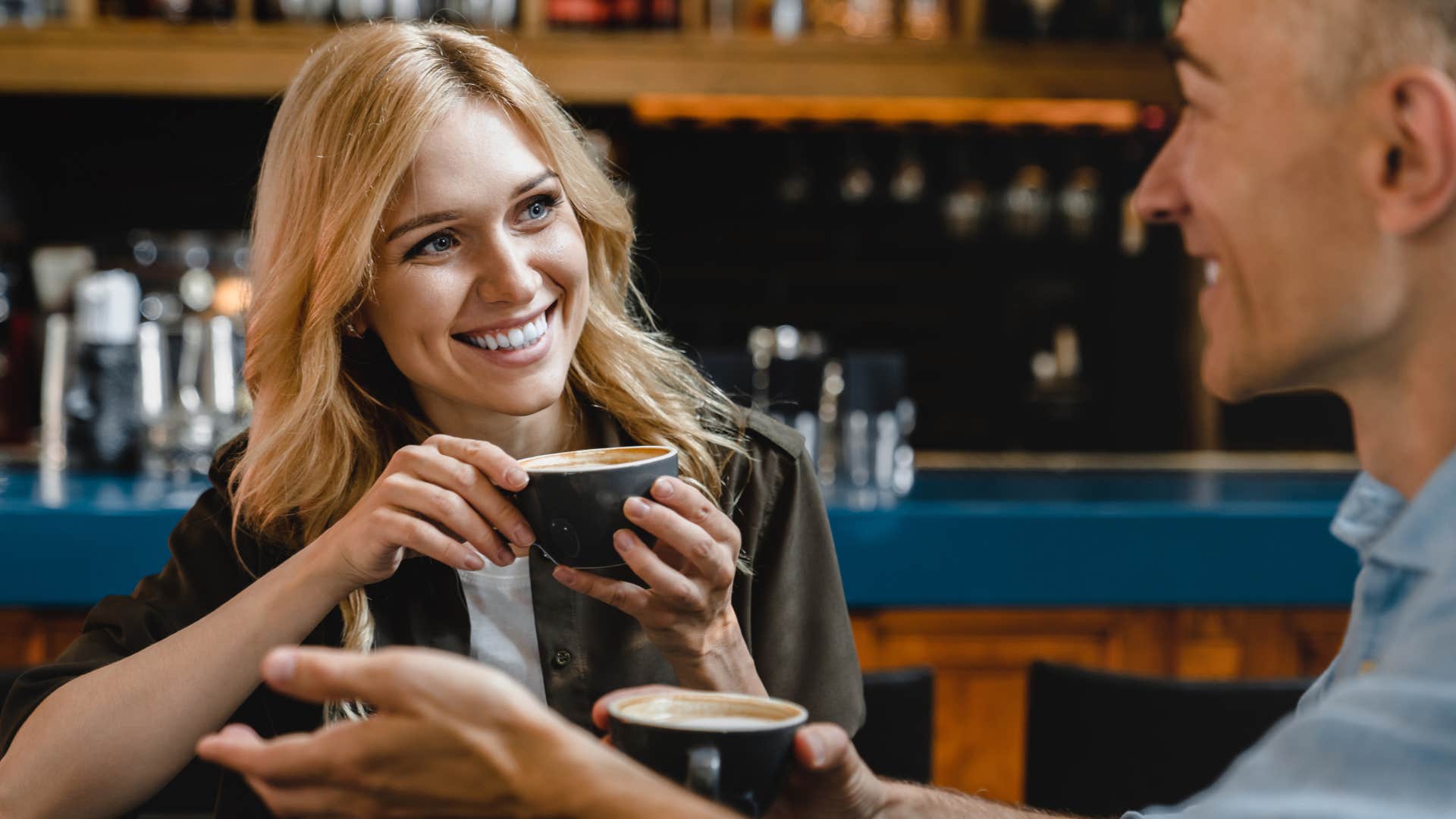 happy woman smiling sipping coffee