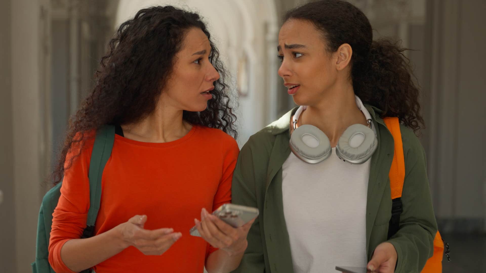 two serious women walking together