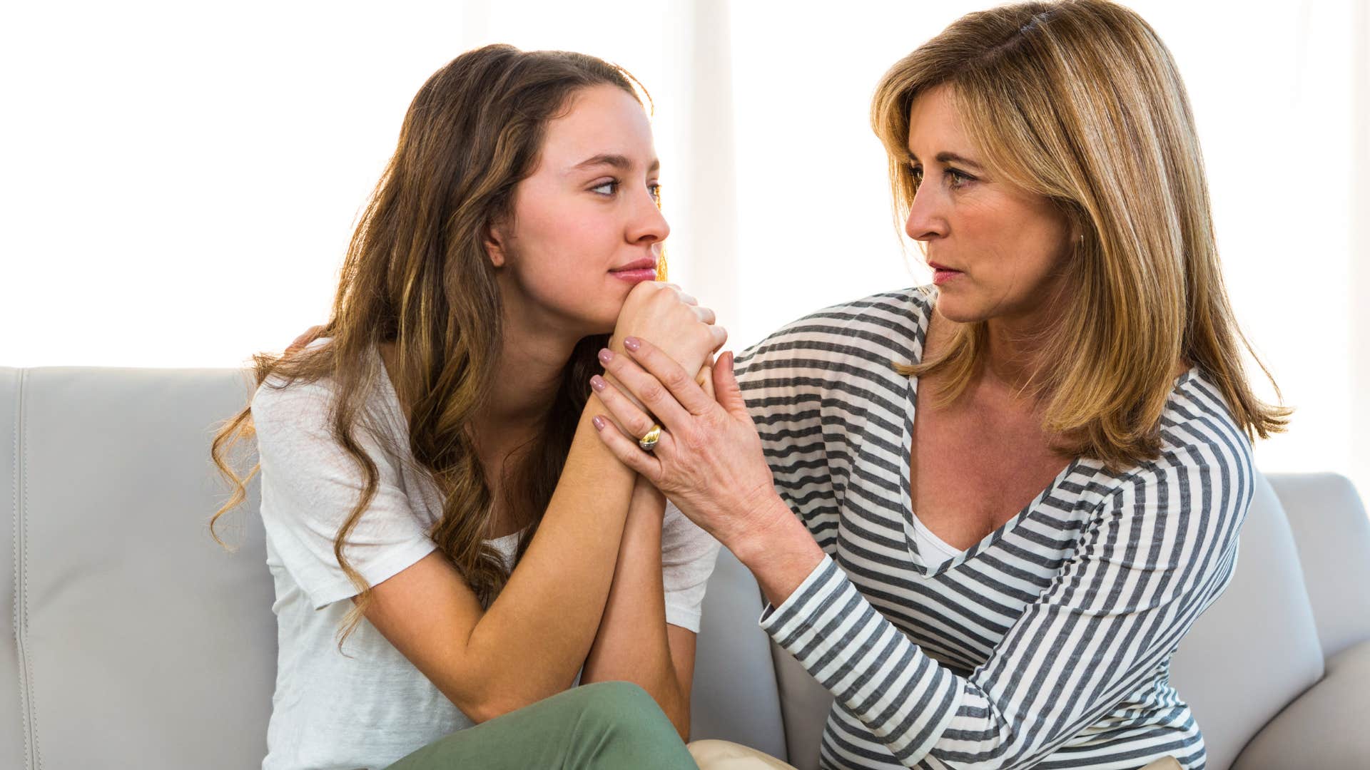 woman comforting her sad teenage daughter