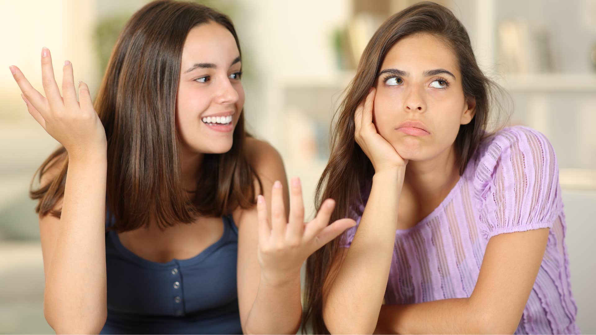 woman talking excitedly while other woman looks away bored