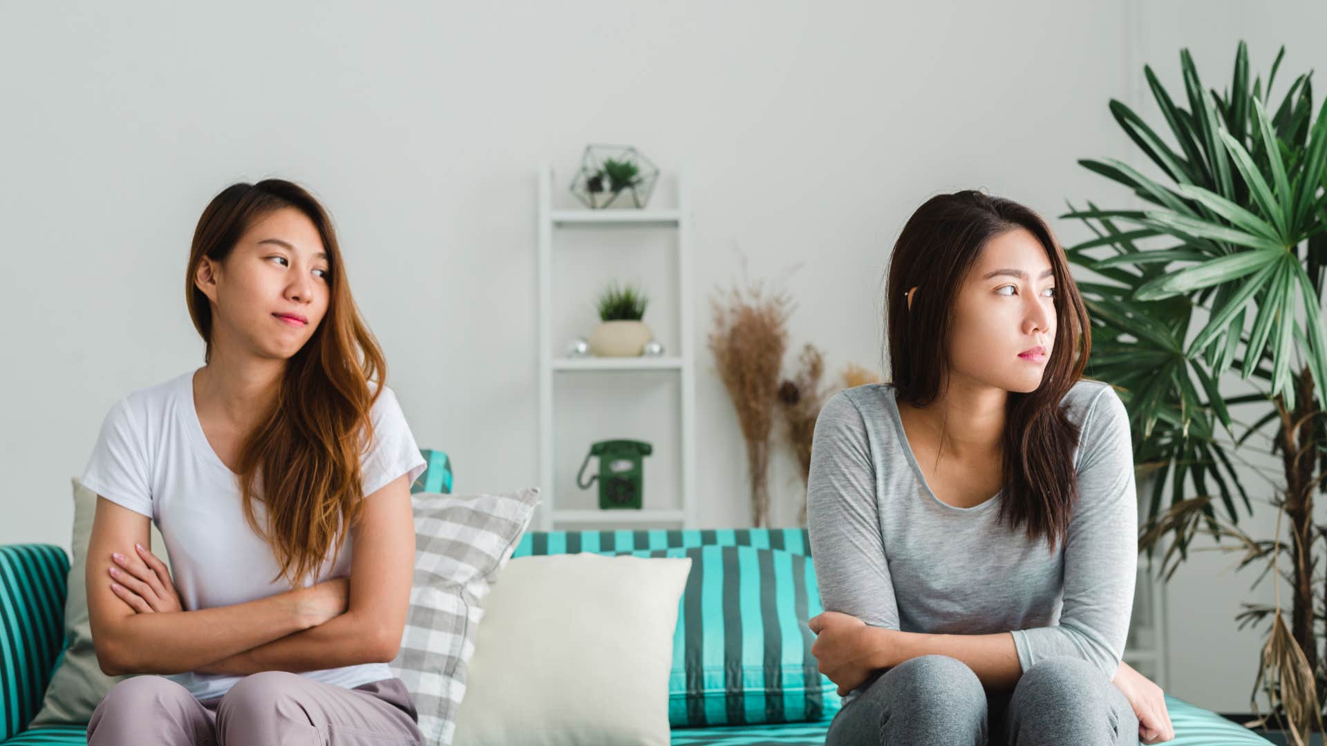 women sitting apart from each other on couch not talking