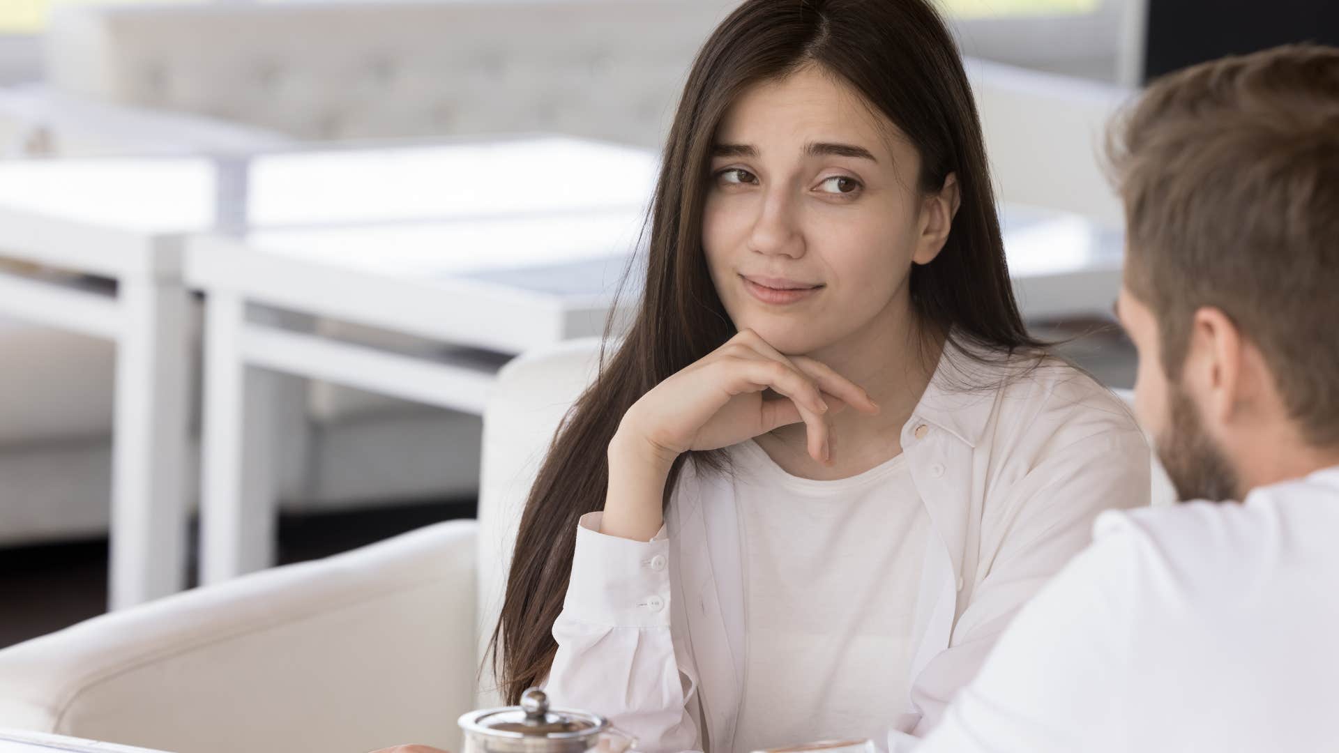 woman looking skeptically at man she is talking to