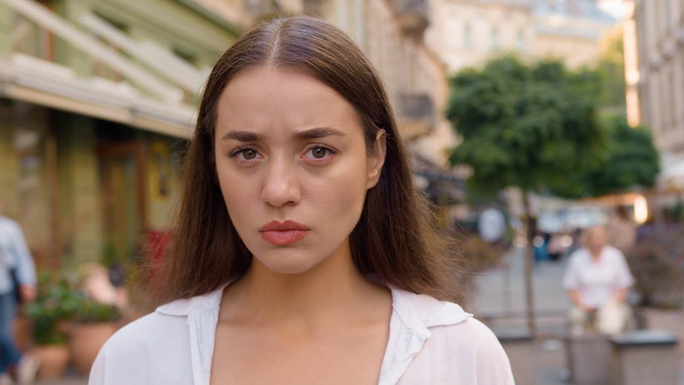 sad woman standing on the street