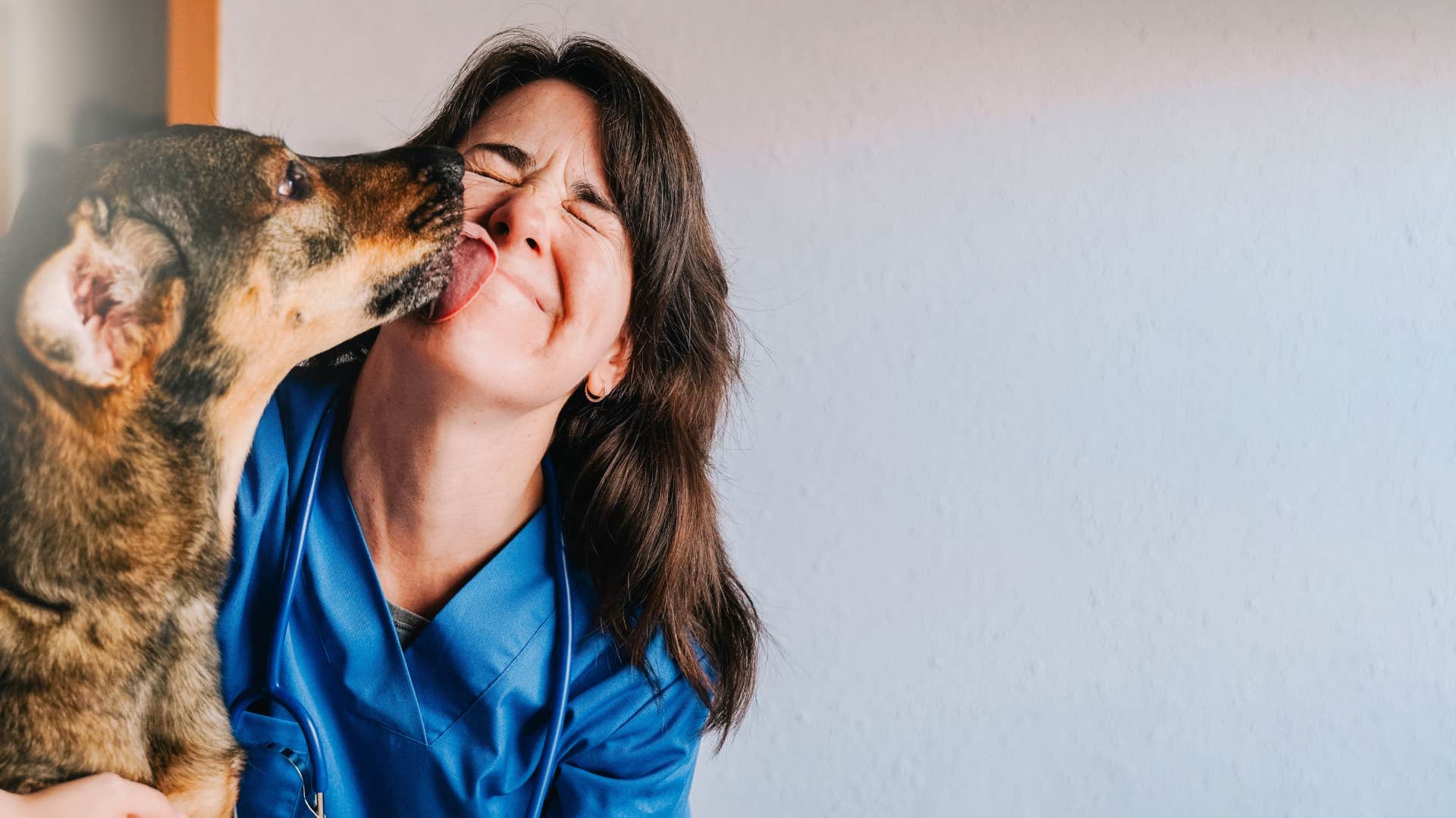 dog licking woman's face