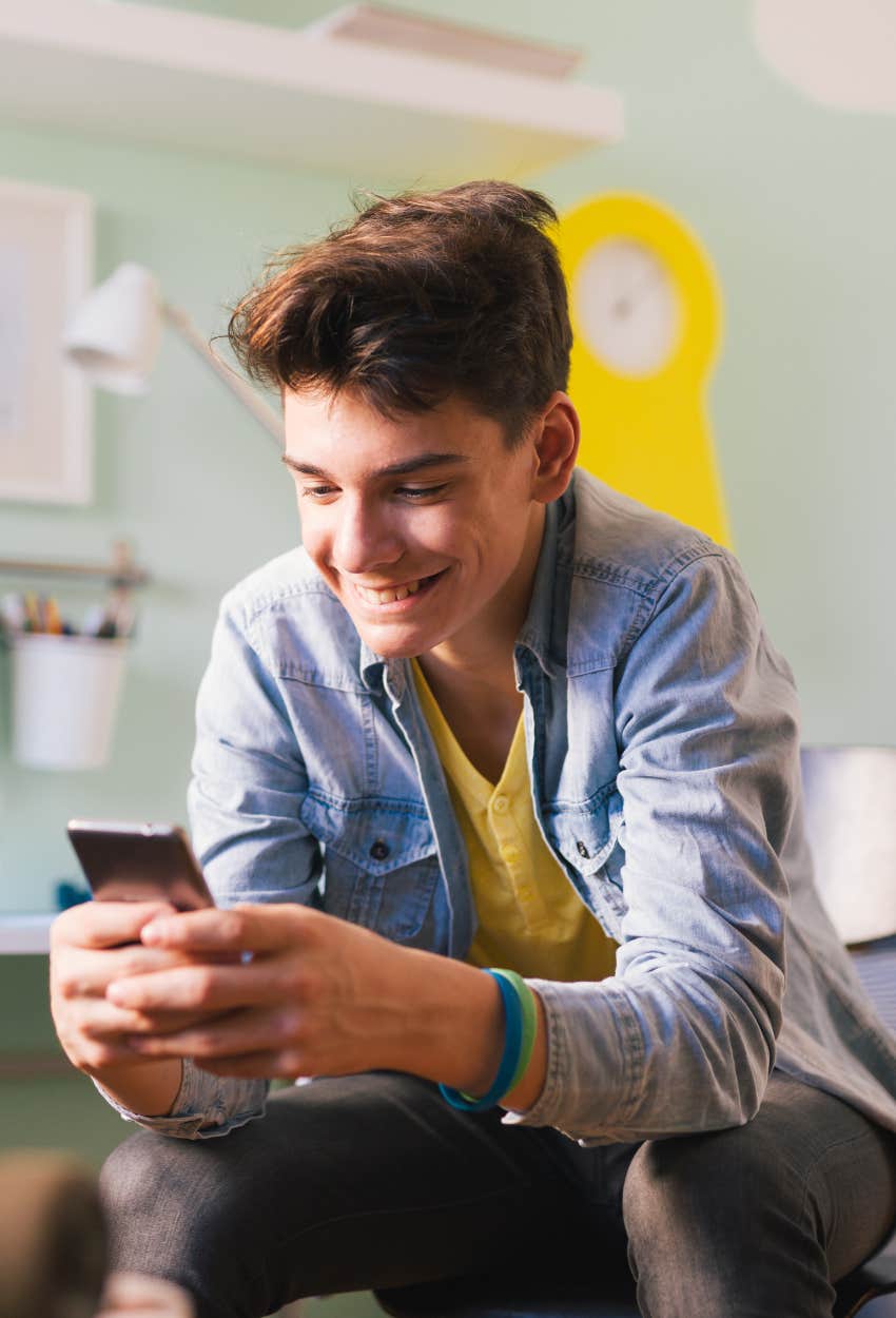 Teen boy on social media on his phone after australia's social media ban